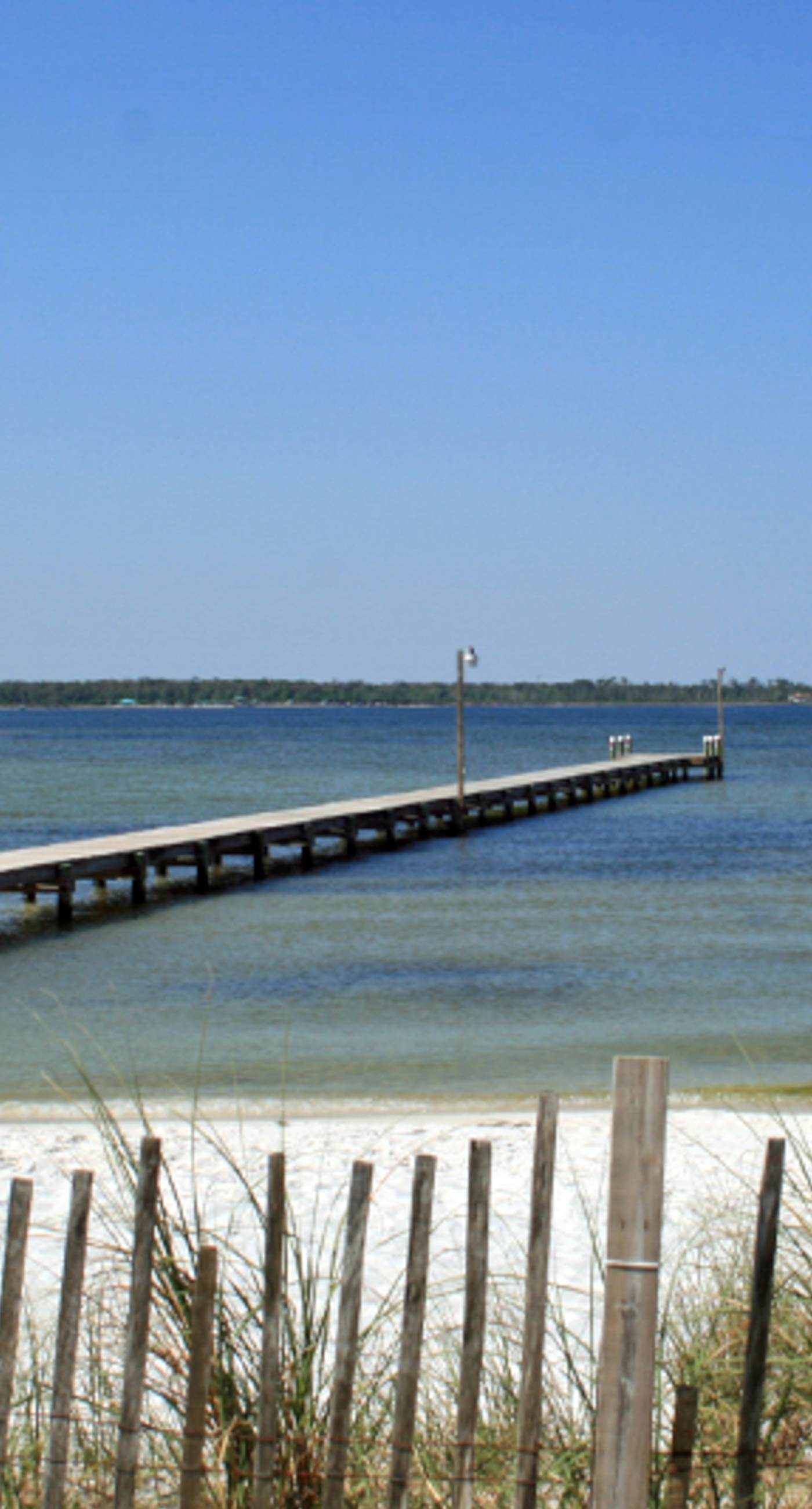 Condo with partial bay view, onsite fishing dock, beach access, & shared pool