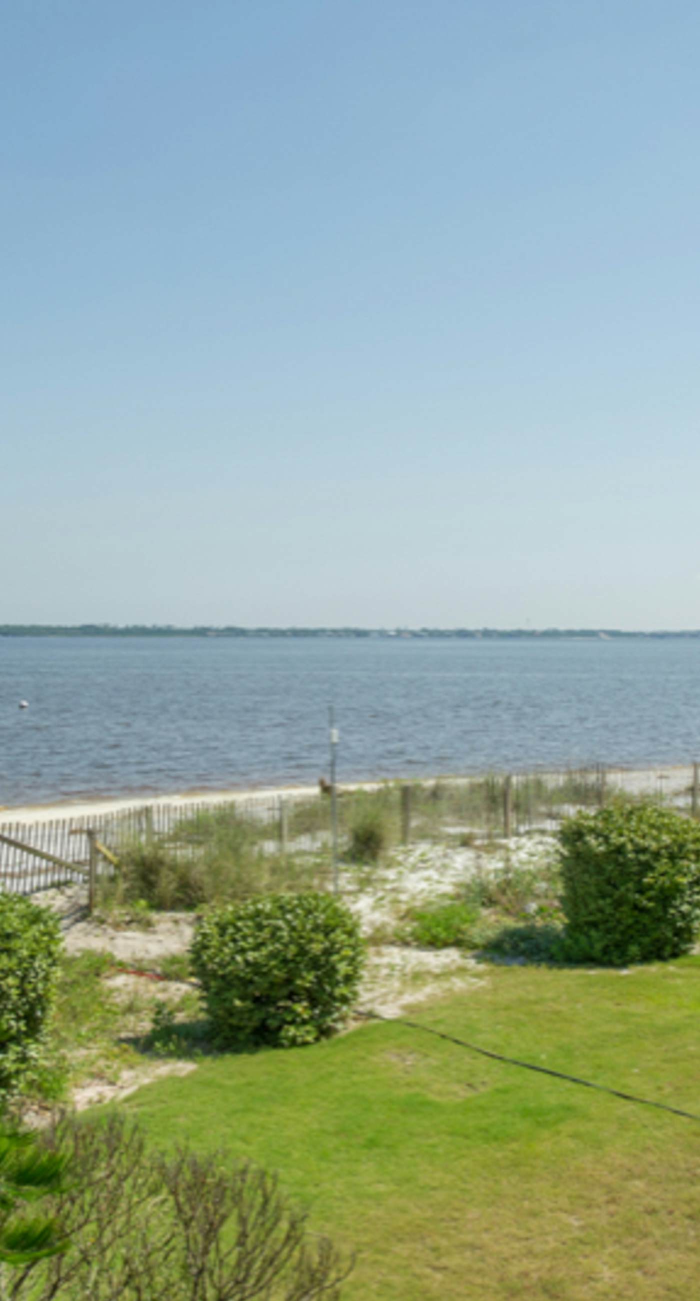 Inviting condo with bay & ocean views, & pool - steps to the beach