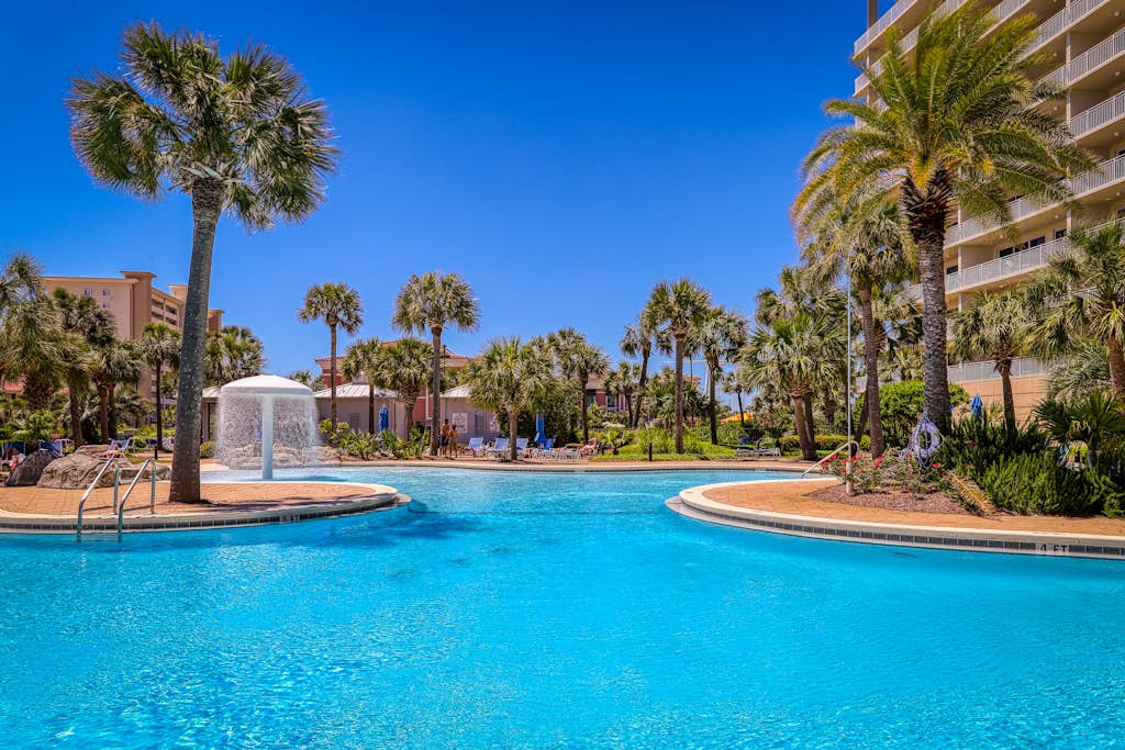 Elegant condo w/ water views, private balcony, shared fitness center and grills