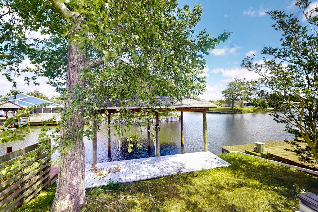 Two-story waterfront retreat with a furnished deck, washer/dryer, & AC