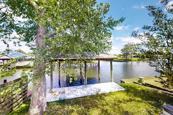 Two-story waterfront retreat with a furnished deck, washer/dryer, & AC