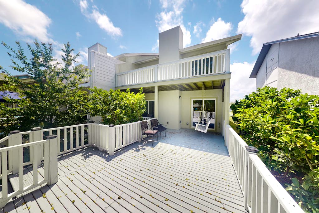 Two-story waterfront retreat with a furnished deck, washer/dryer, & AC