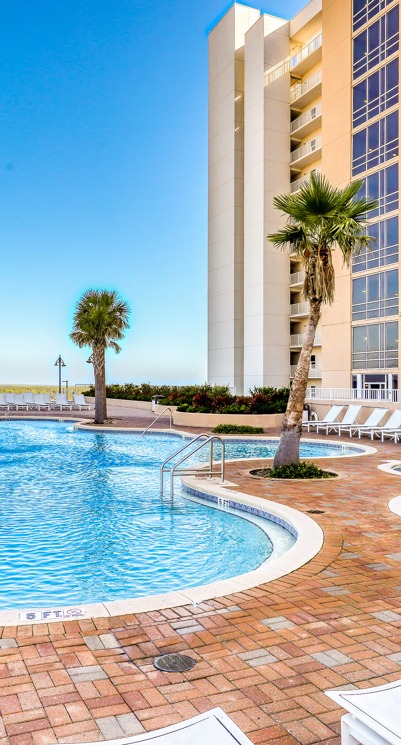Gulf-view condo steps to beach with balcony, pools, hot tub & gym