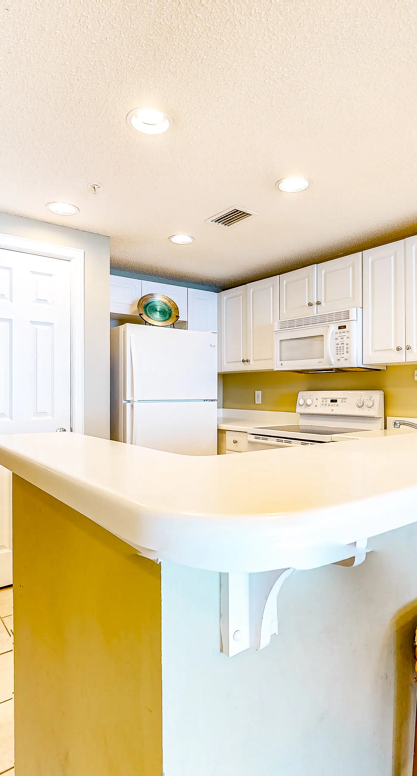 Sun-soaked oceanfront escape with pool, hot tub, central AC, & tennis court