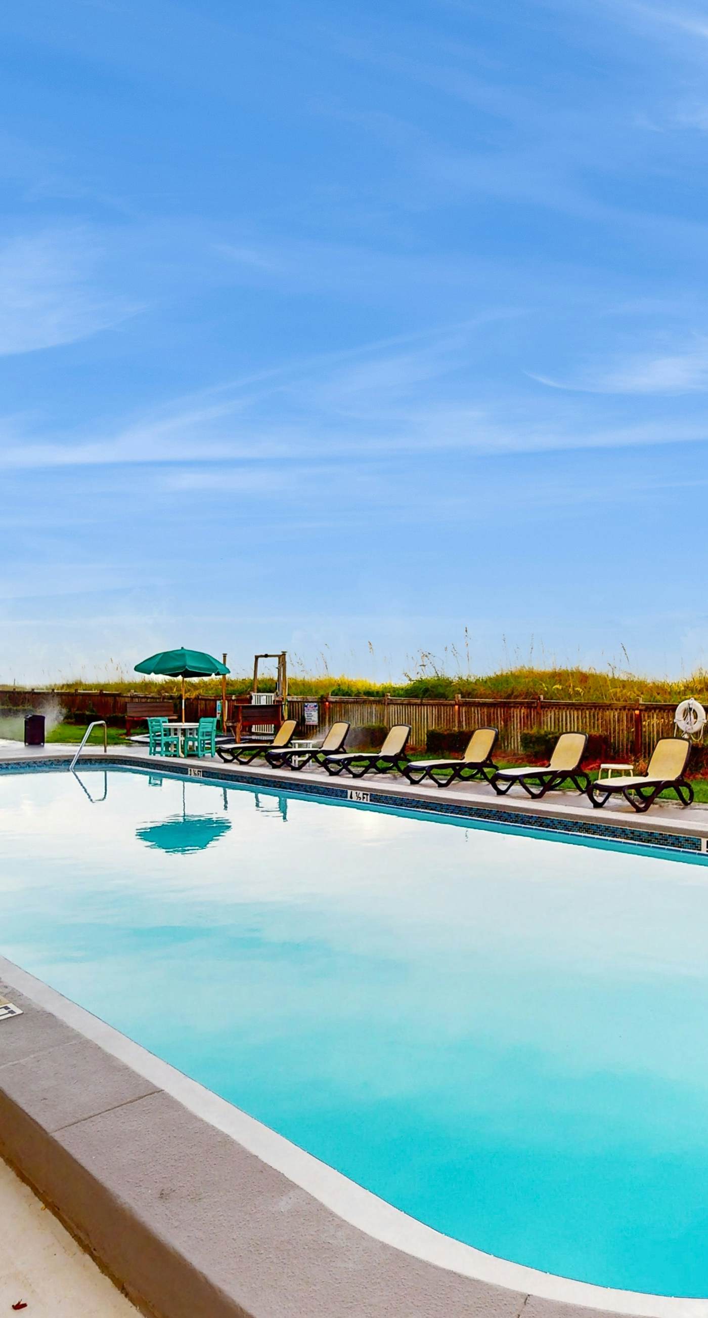 Oceanfront condo with shared pool, resort amenities, and private washer/dryer