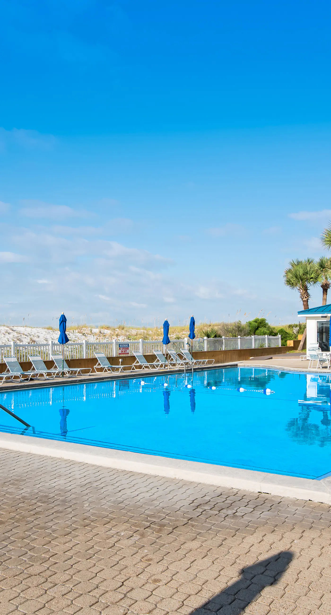 Light-filled beachfront condo with shared pool, hot tub & beach access