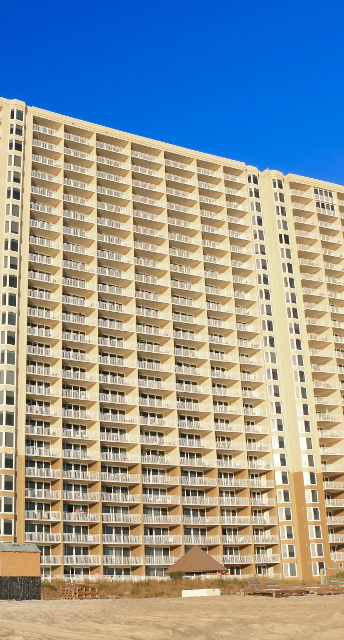 Light-filled beachfront condo with shared pool, hot tub & beach access