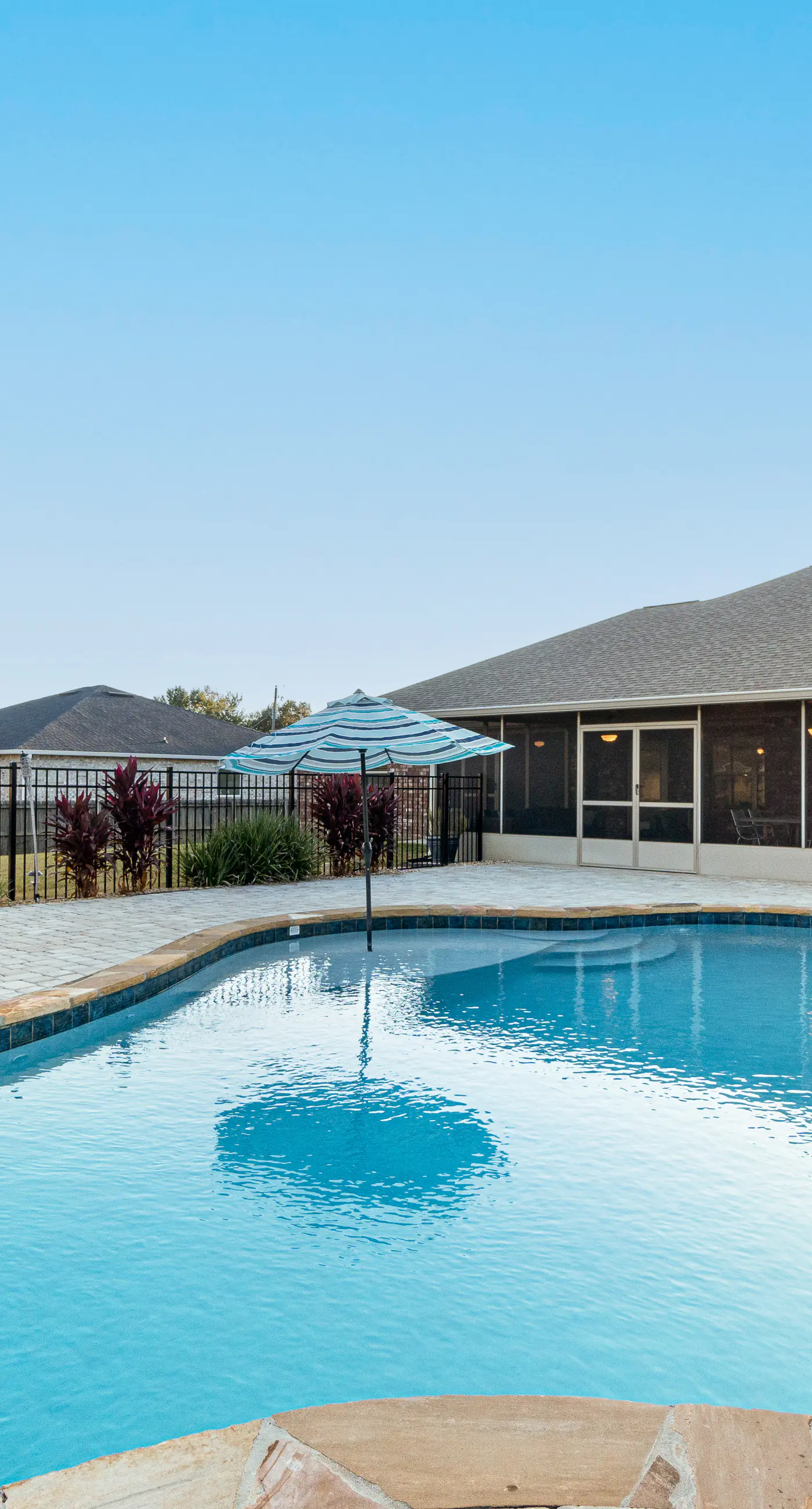 Single-level home with pool, enclosed yard, screened lanai, grill & home office