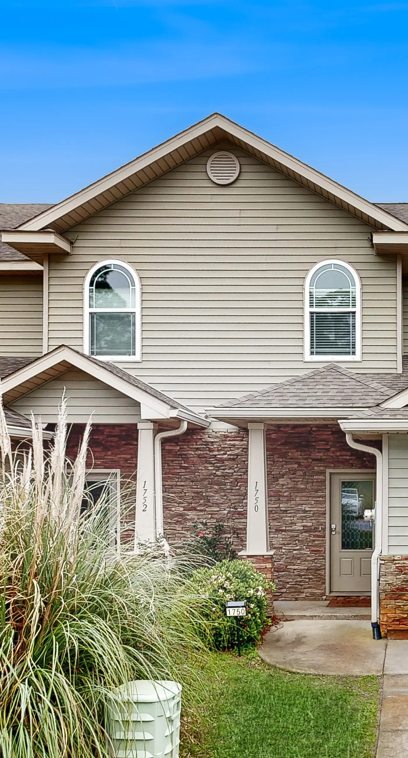 Inviting, two-story home with furnished patio, washer/dryer, & pool access