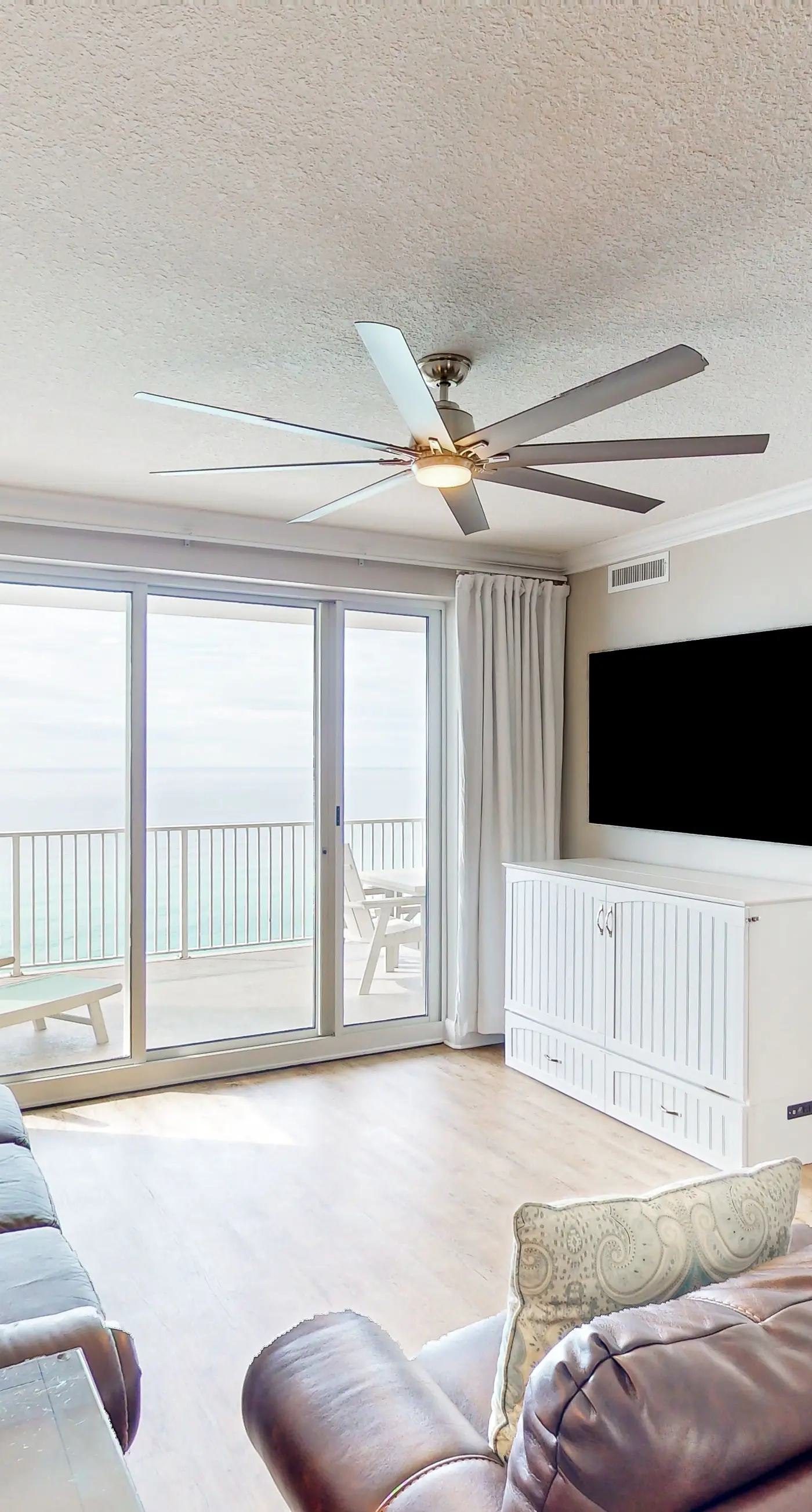 Oceanfront condo with scenic balcony, resort amenities, central AC, & W/D
