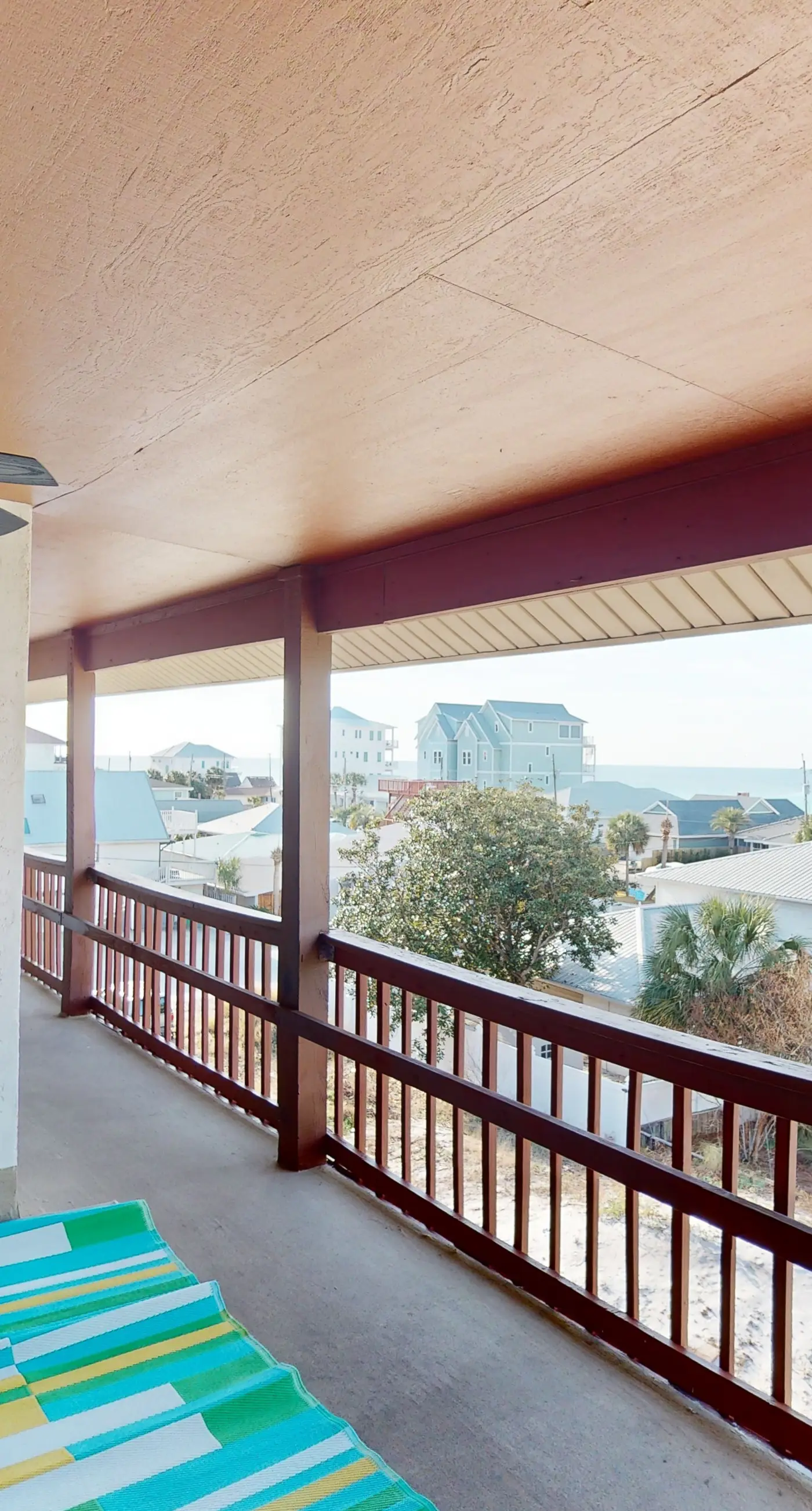 Gulf-view 2-story condo near the beach with porch, streaming, W/D, & central AC