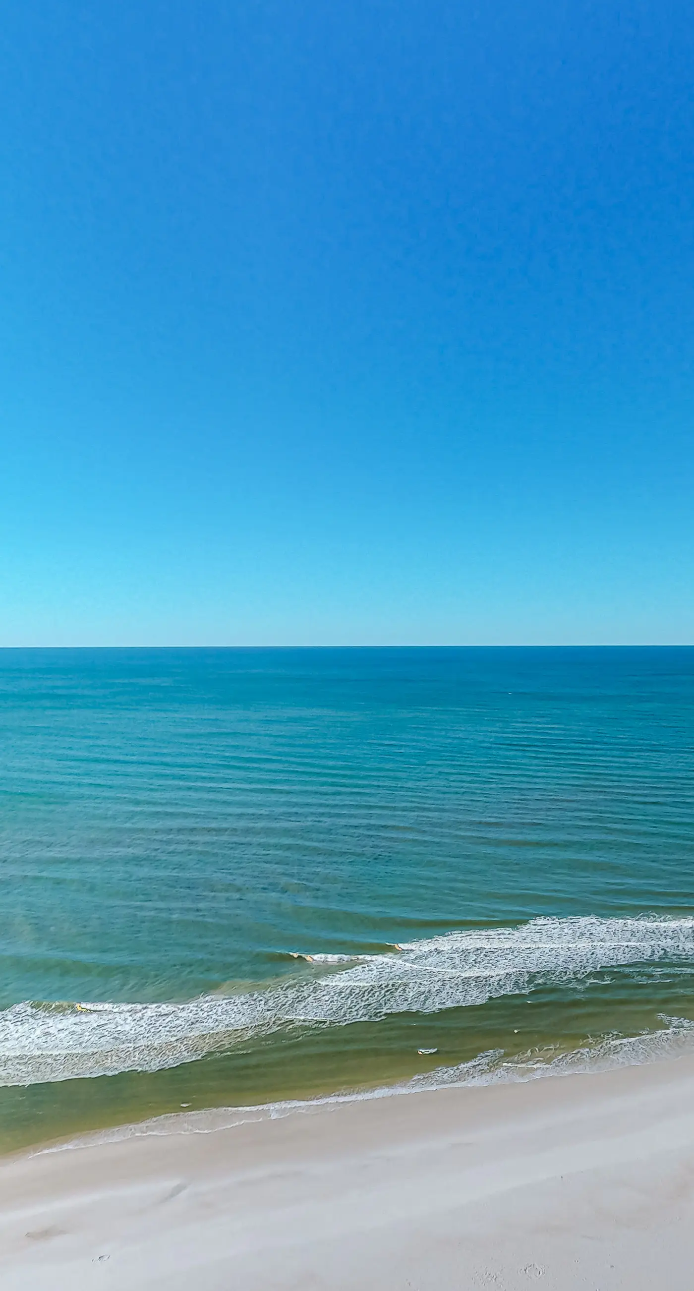 High-end beachfront condo with pools & gym - walk to the beach