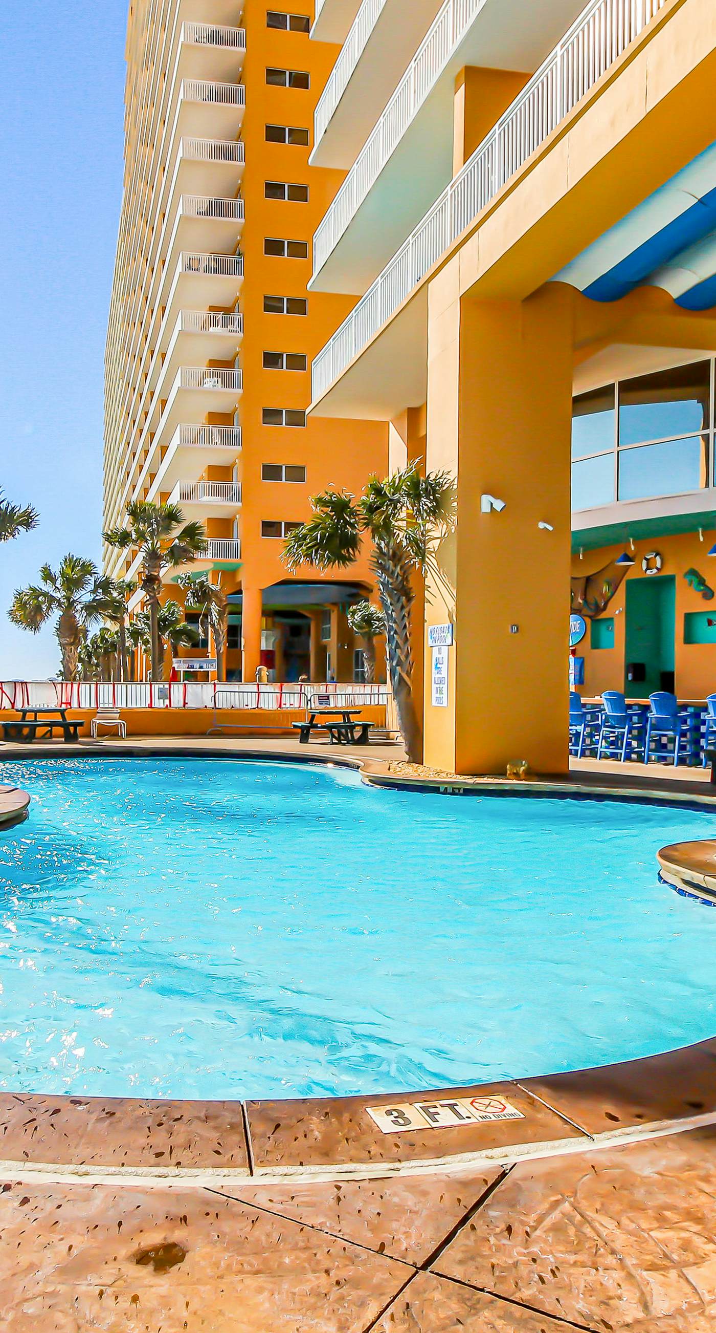 Colorful, beachfront condo with Gulf view, pool, hot tub, and lazy river