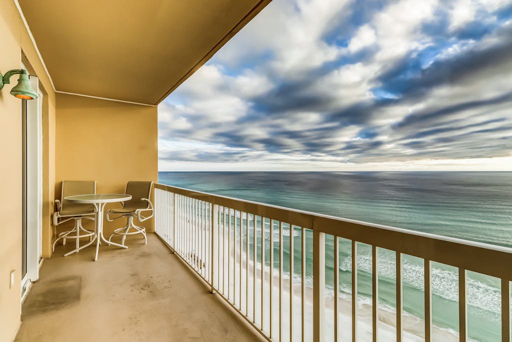 Serene & upscale beachfront condo with furnished balcony, view, & pools