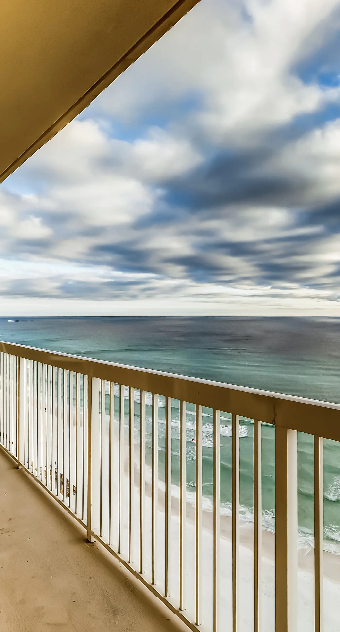 Serene & upscale beachfront condo with furnished balcony, view, & pools