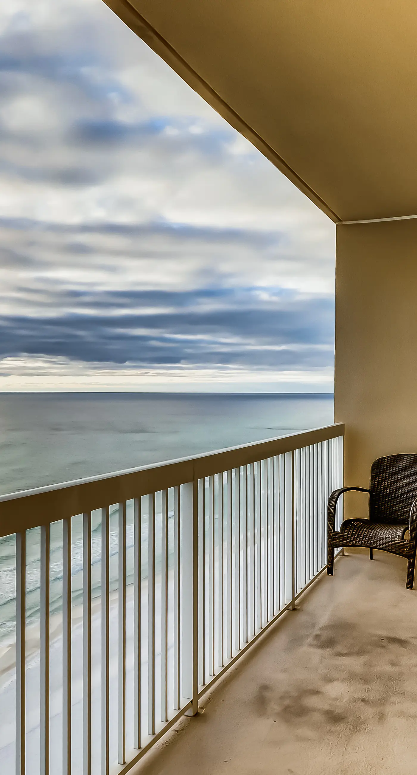 Serene & upscale beachfront condo with furnished balcony, view, & pools