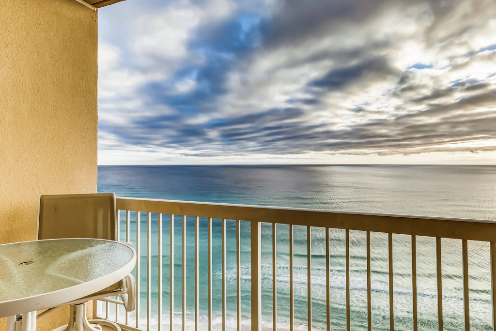Serene & upscale beachfront condo with furnished balcony, view, & pools