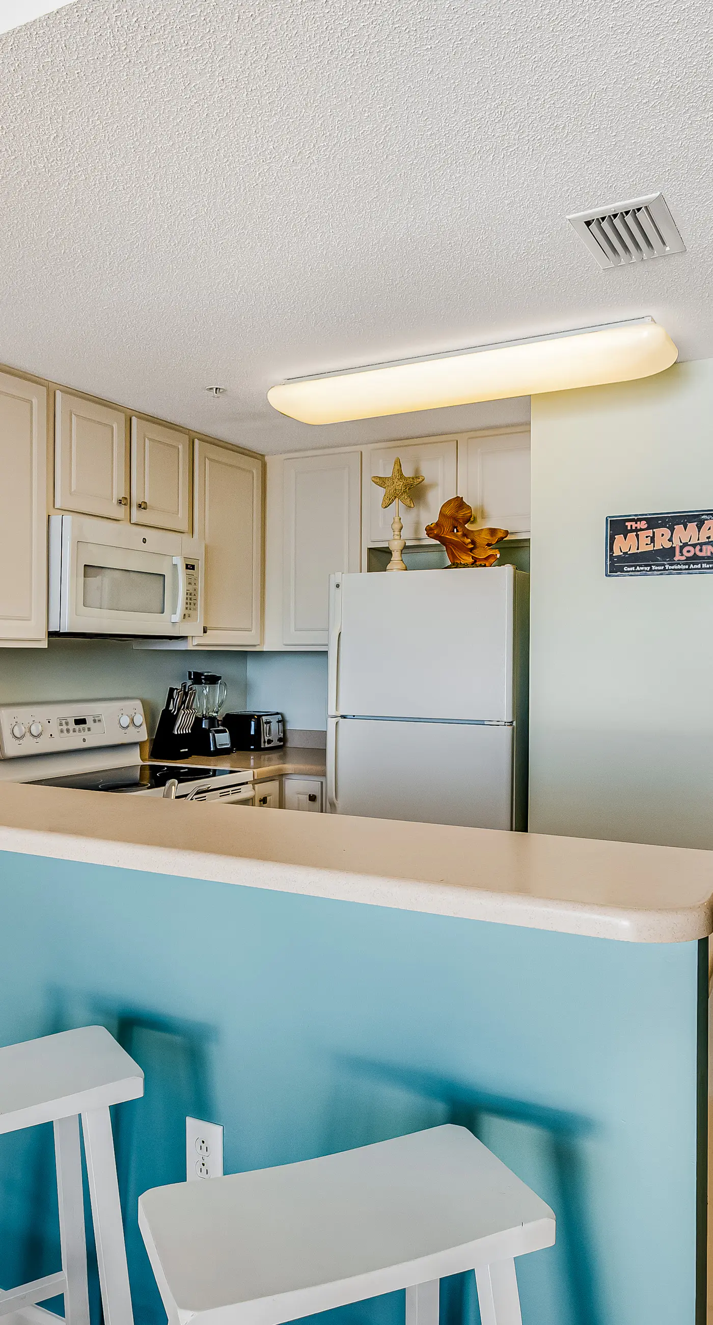 Tropical, waterfront oasis with furnished balcony, pools, & beach access