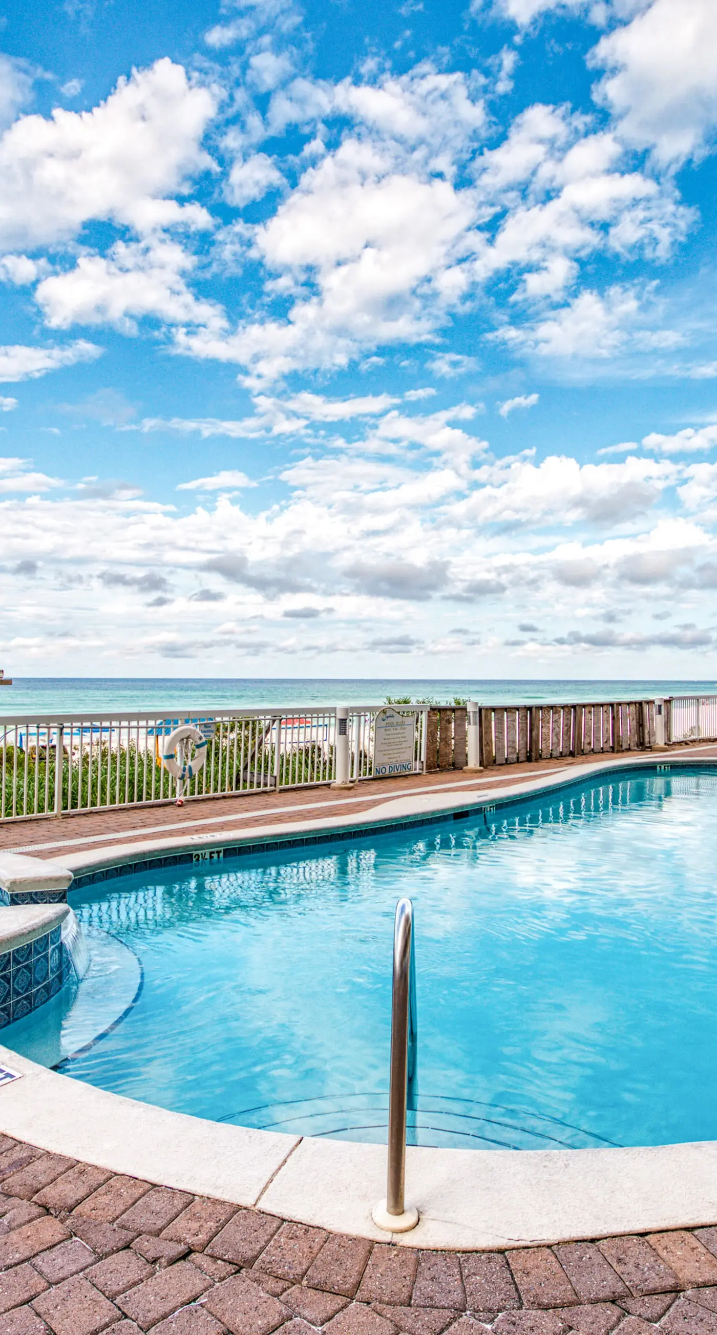 Cozy & colorful beachfront condo with balcony, pools, & fitness center