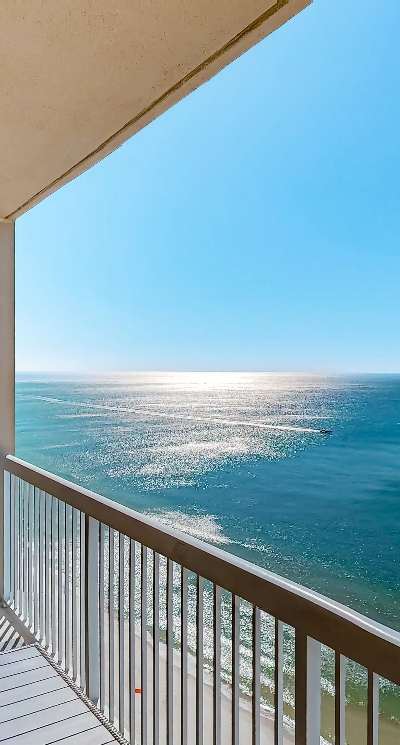 Cozy & colorful beachfront condo with balcony, pools, & fitness center