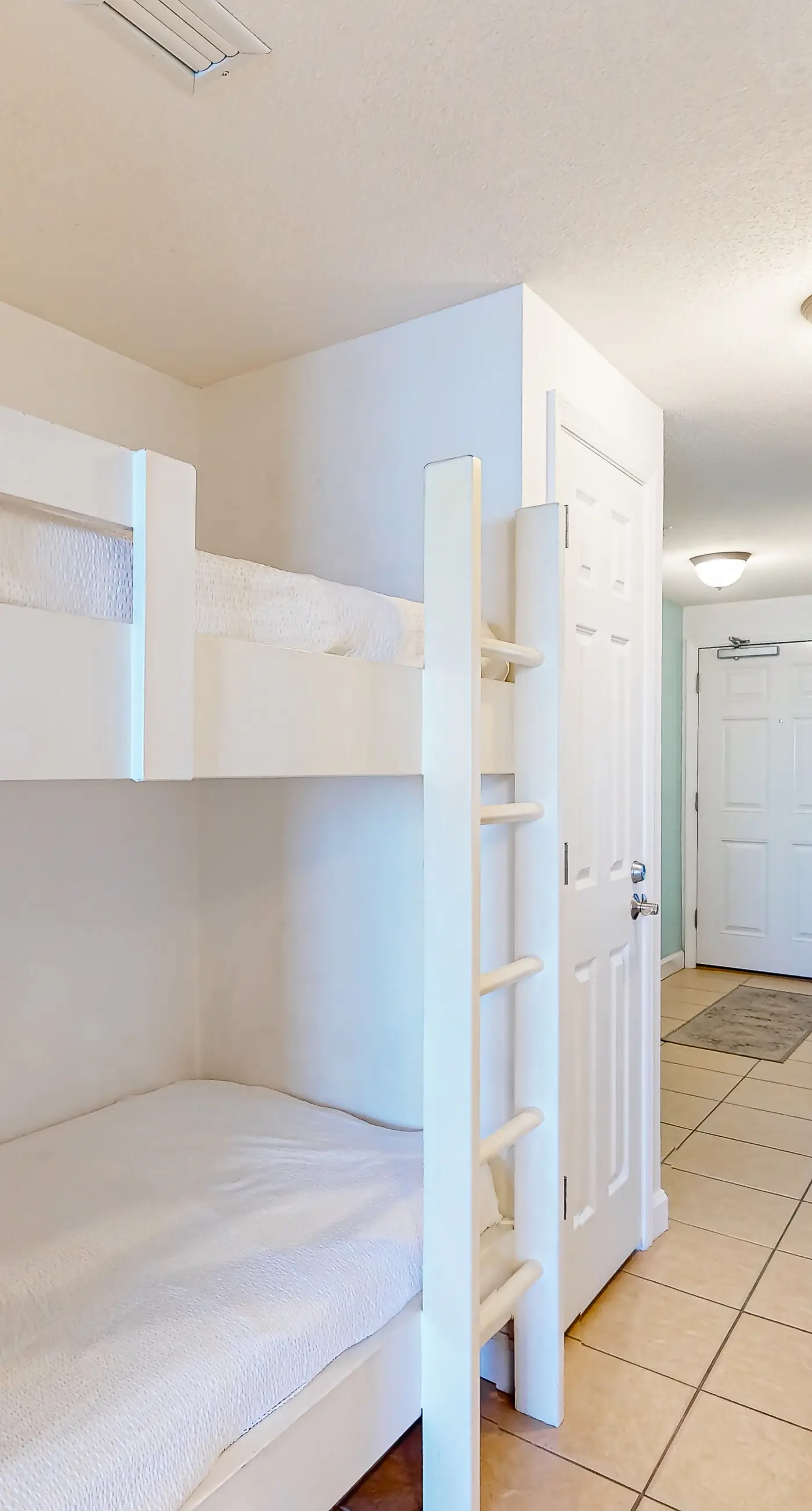 Cozy & colorful beachfront condo with balcony, pools, & fitness center