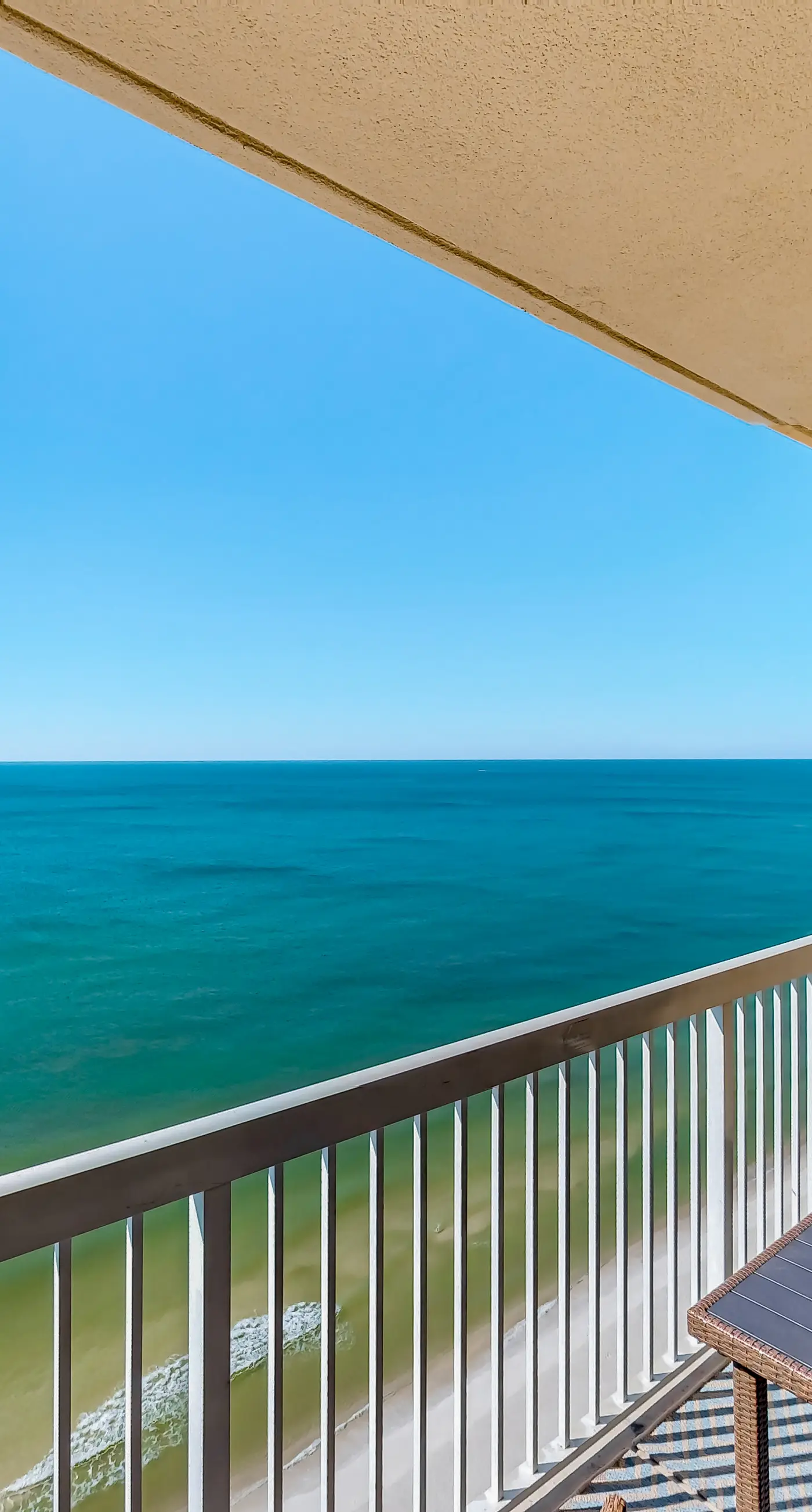 Cozy & colorful beachfront condo with balcony, pools, & fitness center