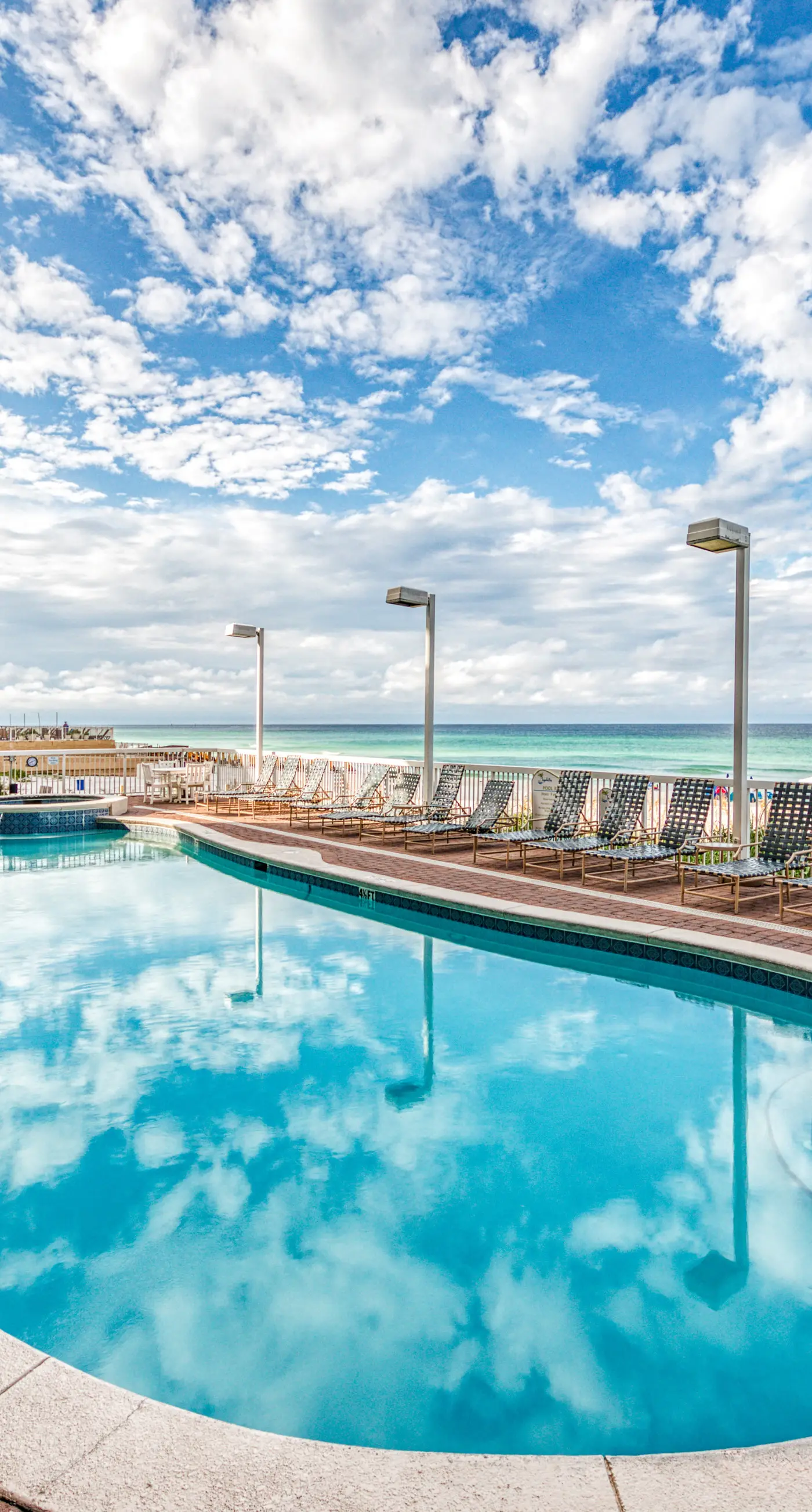 Cozy & colorful beachfront condo with balcony, pools, & fitness center