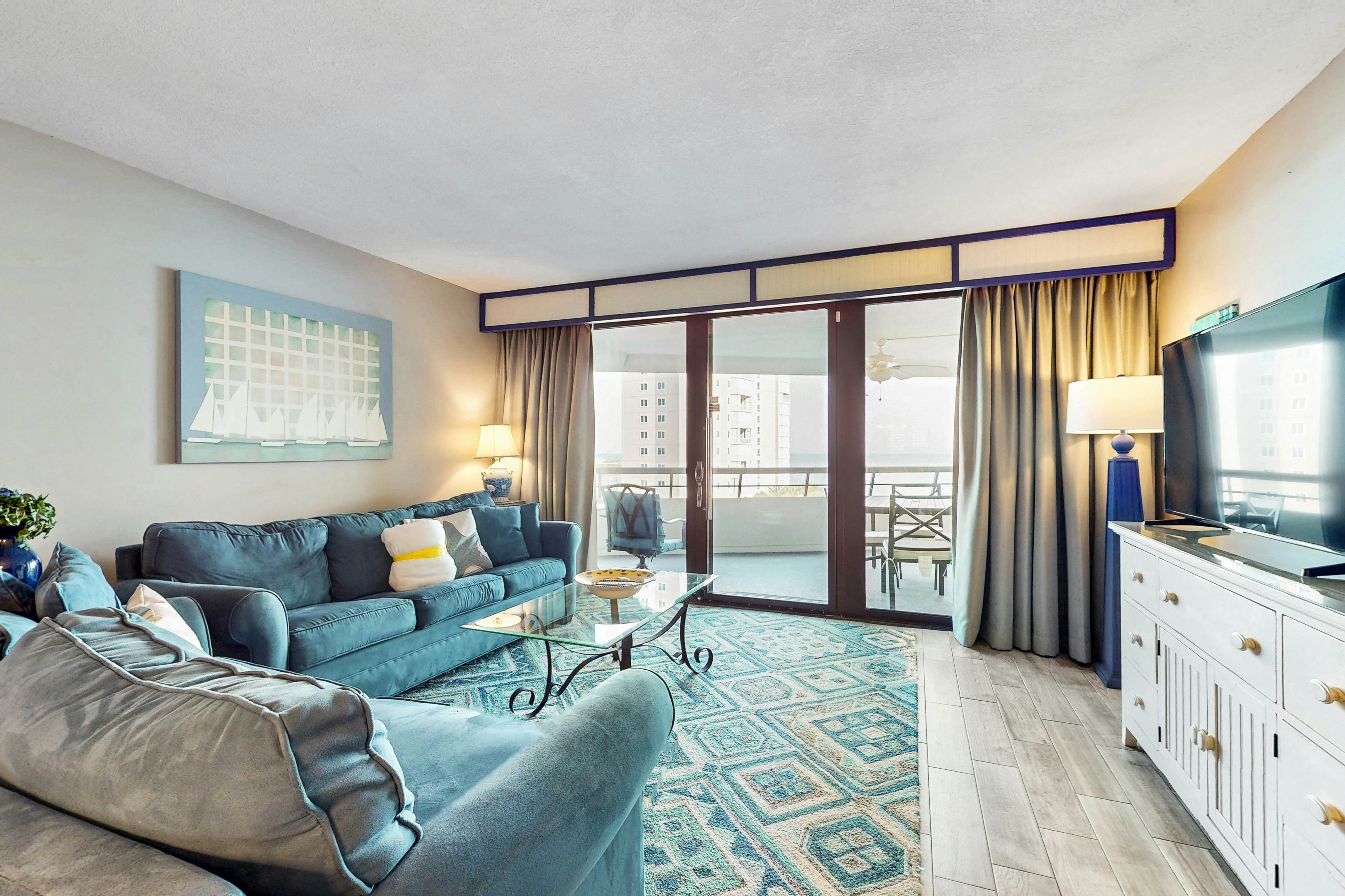 8th floor condo with Gulf views, balcony, pools, hot tubs, central AC, and WiFi