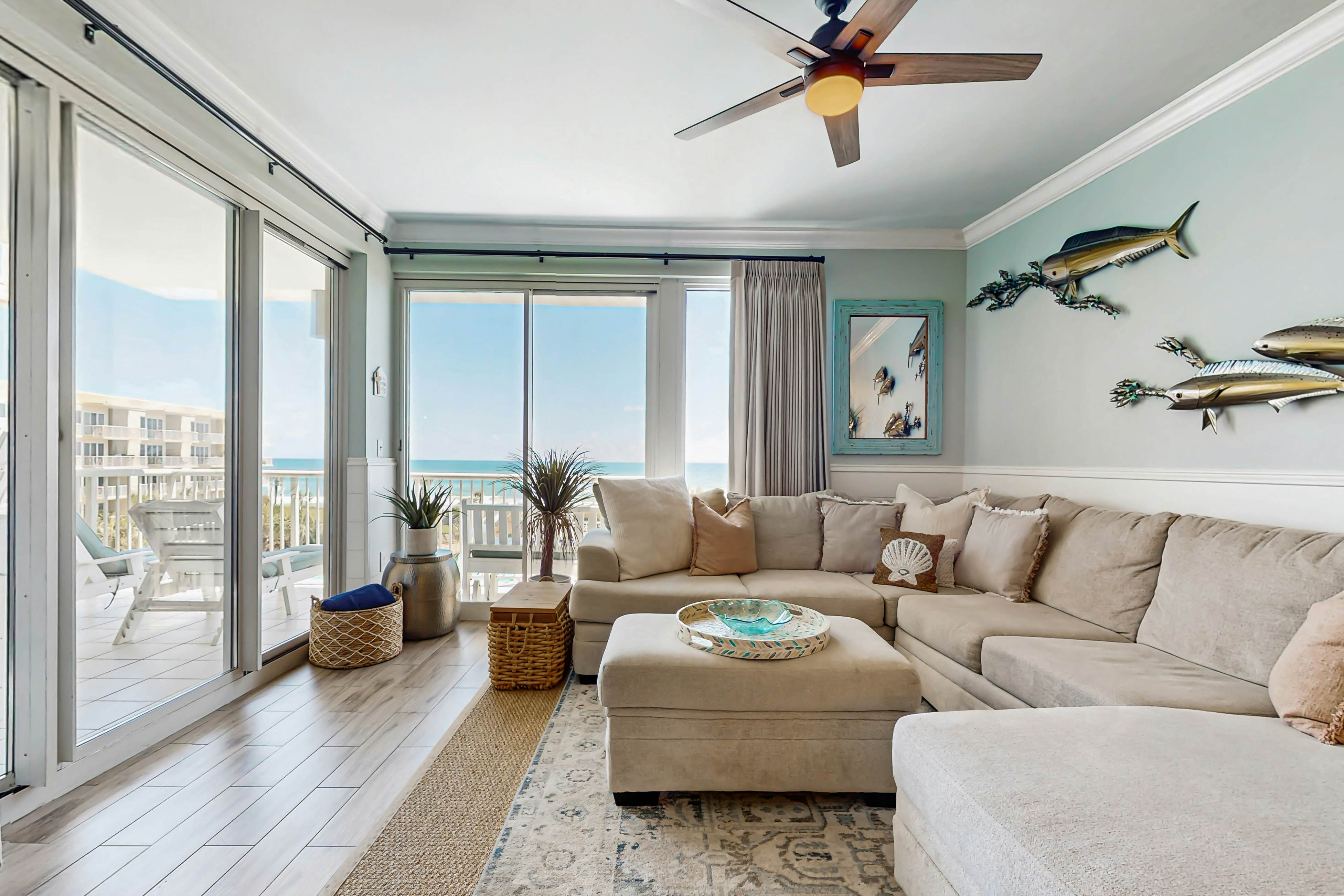Gulf-front condo with balcony and access to pools, hot tub, gym, & private beach