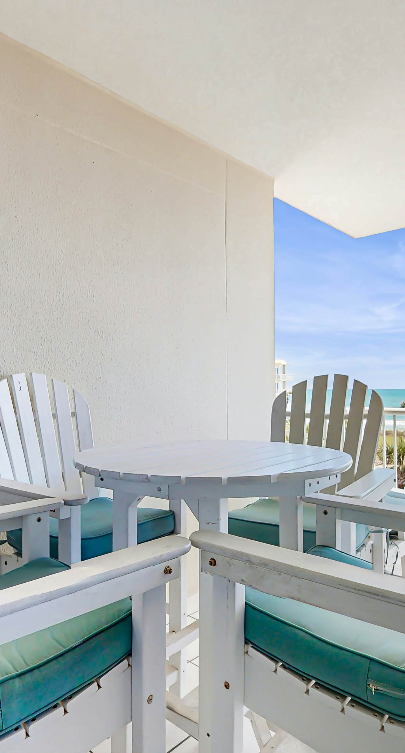 Gulf-front condo with balcony and access to pools, hot tub, gym, & private beach