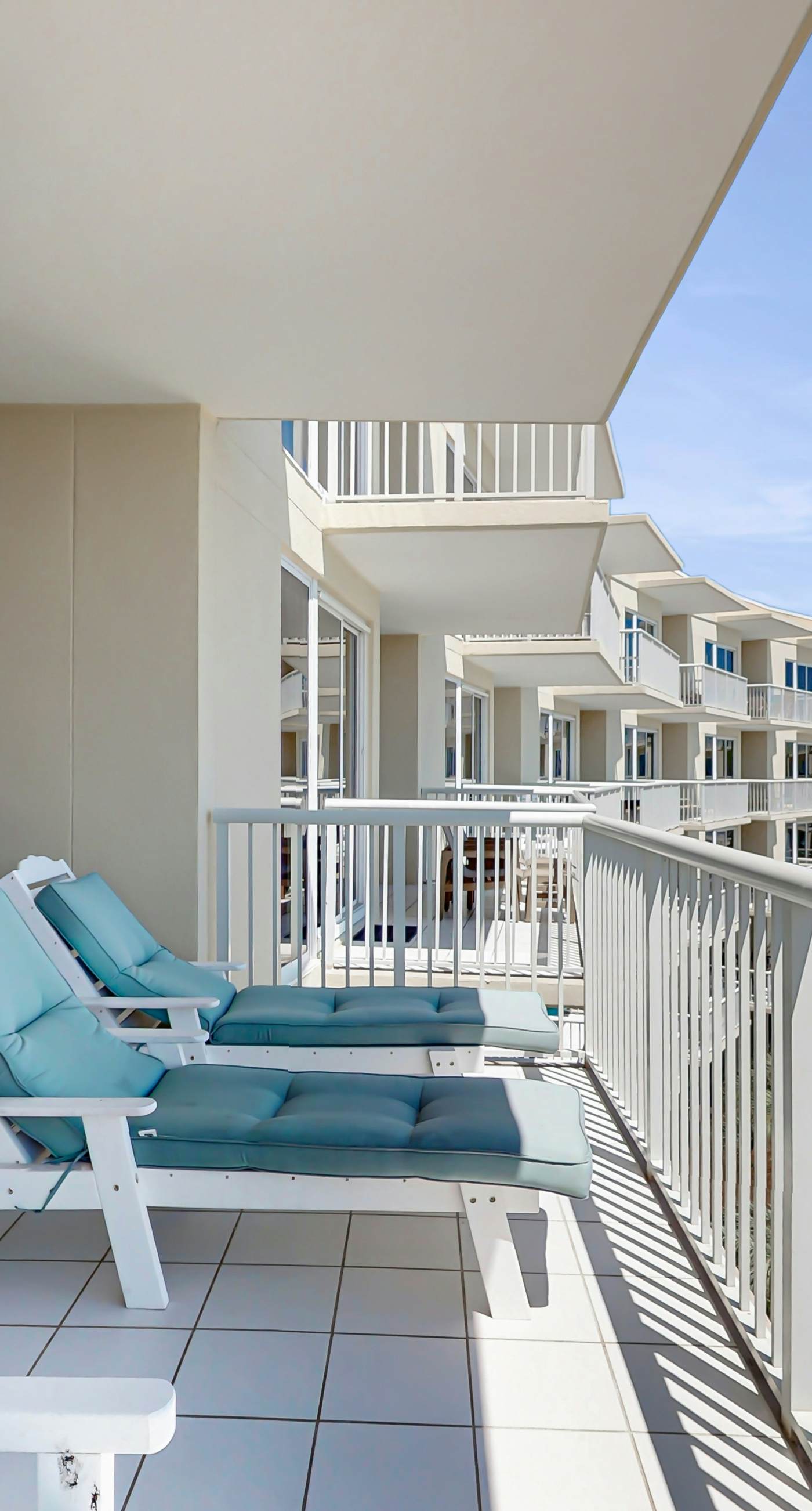 Gulf-front condo with balcony and access to pools, hot tub, gym, & private beach