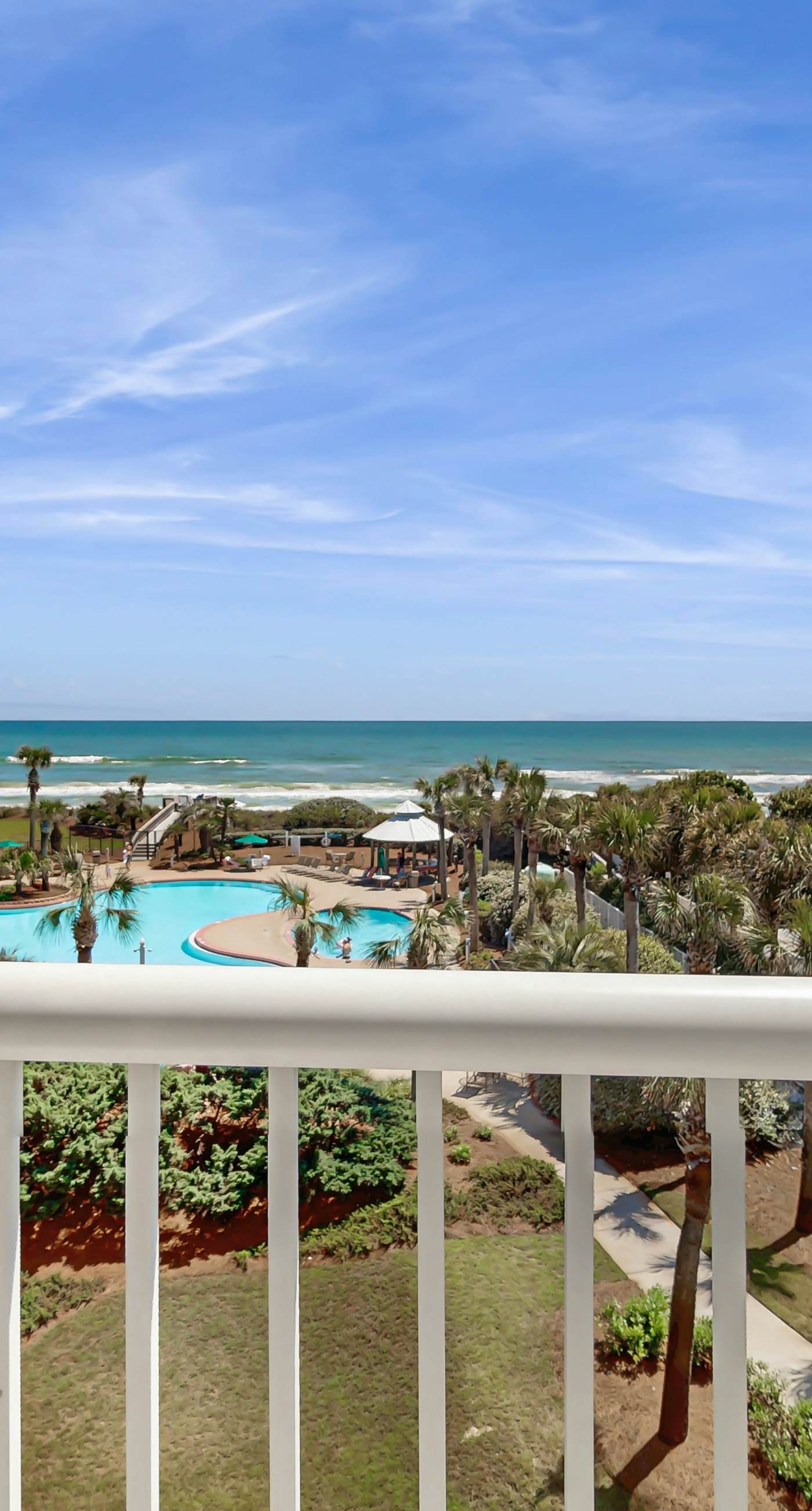 Gulf-front condo with balcony and access to pools, hot tub, gym, & private beach