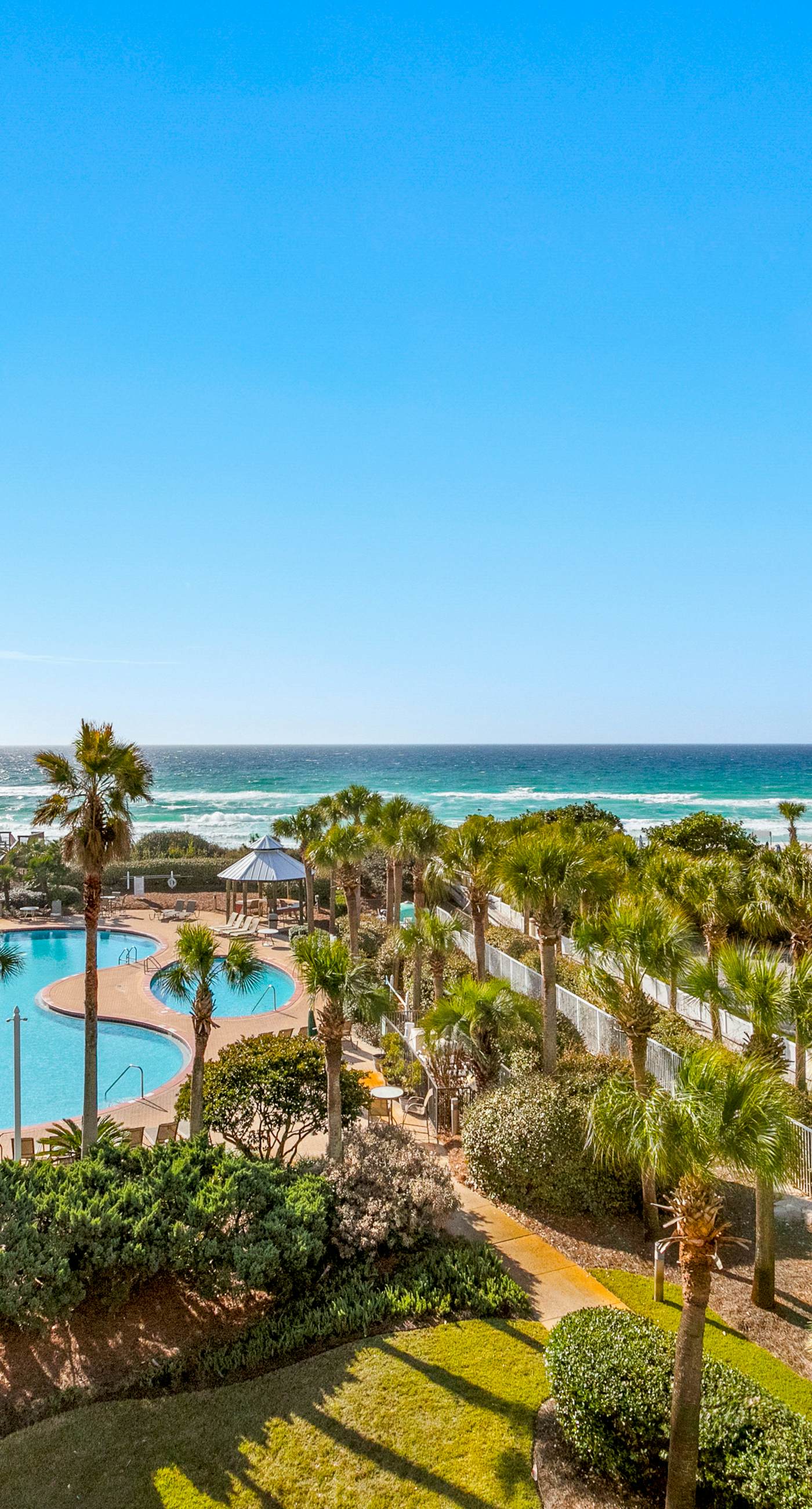 Gulf-front condo with balcony and access to pools, hot tub, gym, & private beach