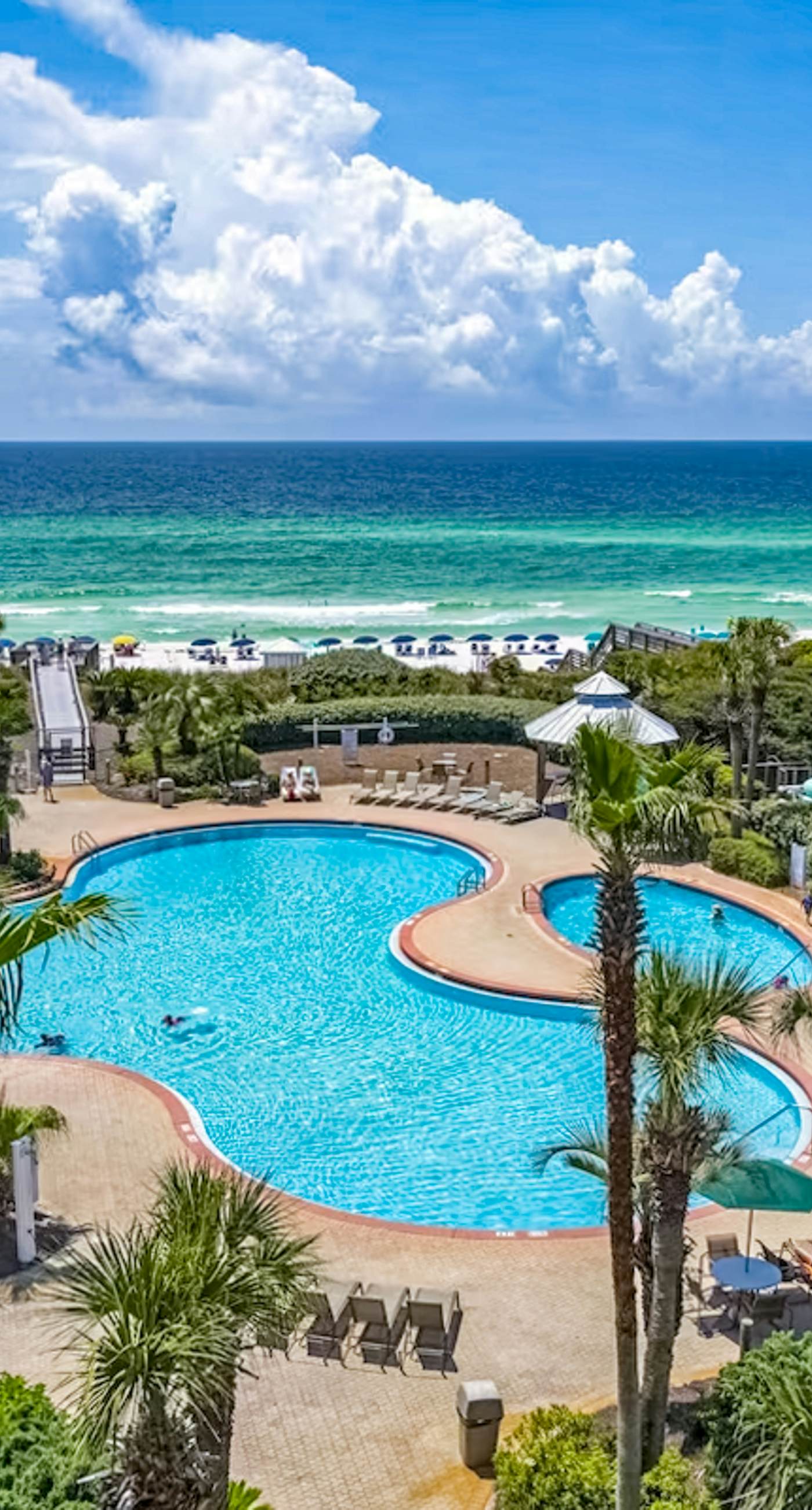 Gulf-front condo with balcony and access to pools, hot tub, gym, & private beach