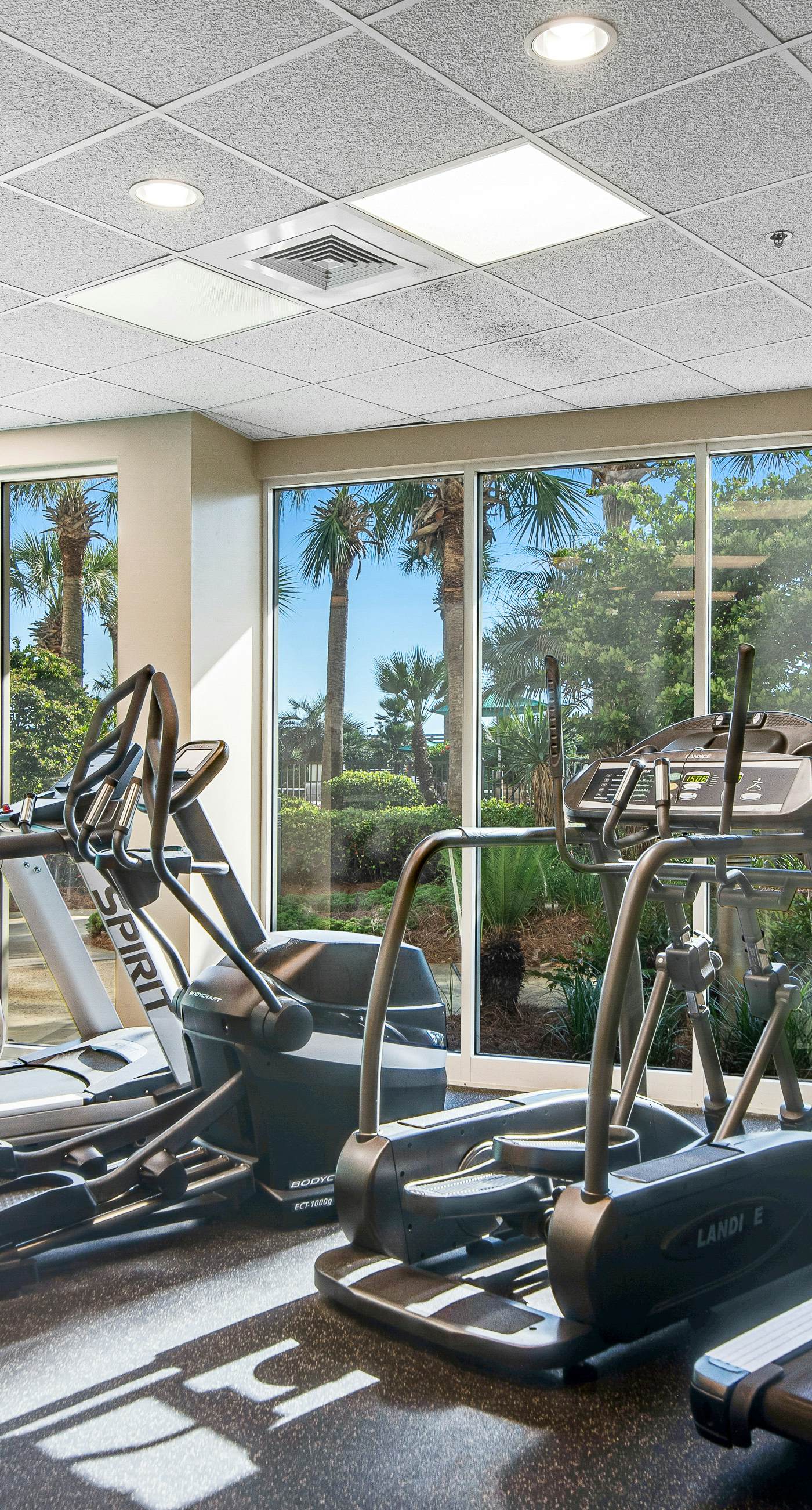 Gulf-front condo with balcony and access to pools, hot tub, gym, & private beach