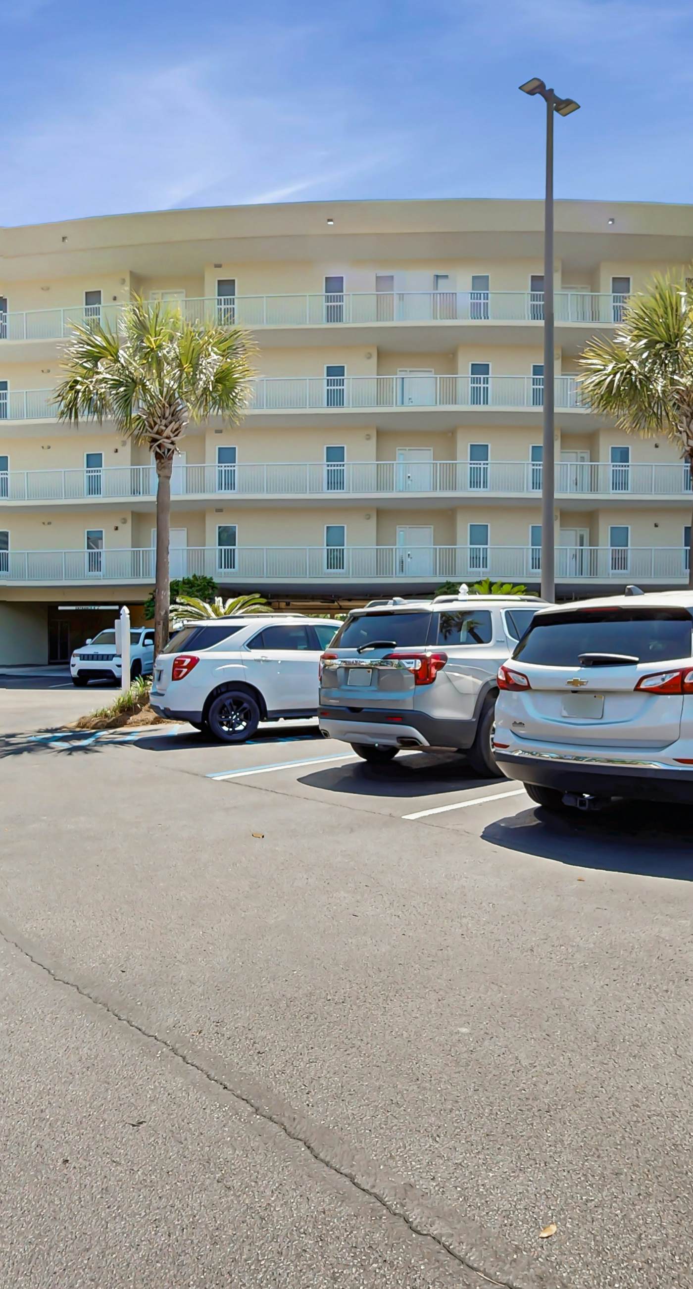 Gulf-front condo with balcony and access to pools, hot tub, gym, & private beach