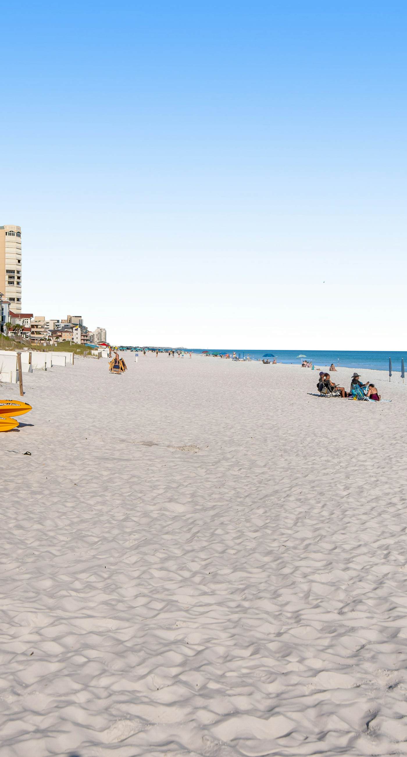 Gulf-front condo with balcony and access to pools, hot tub, gym, & private beach