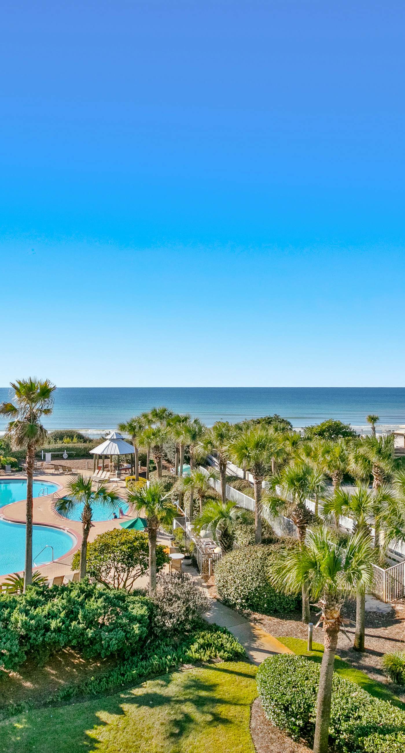 Gulf-front condo with balcony and access to pools, hot tub, gym, & private beach