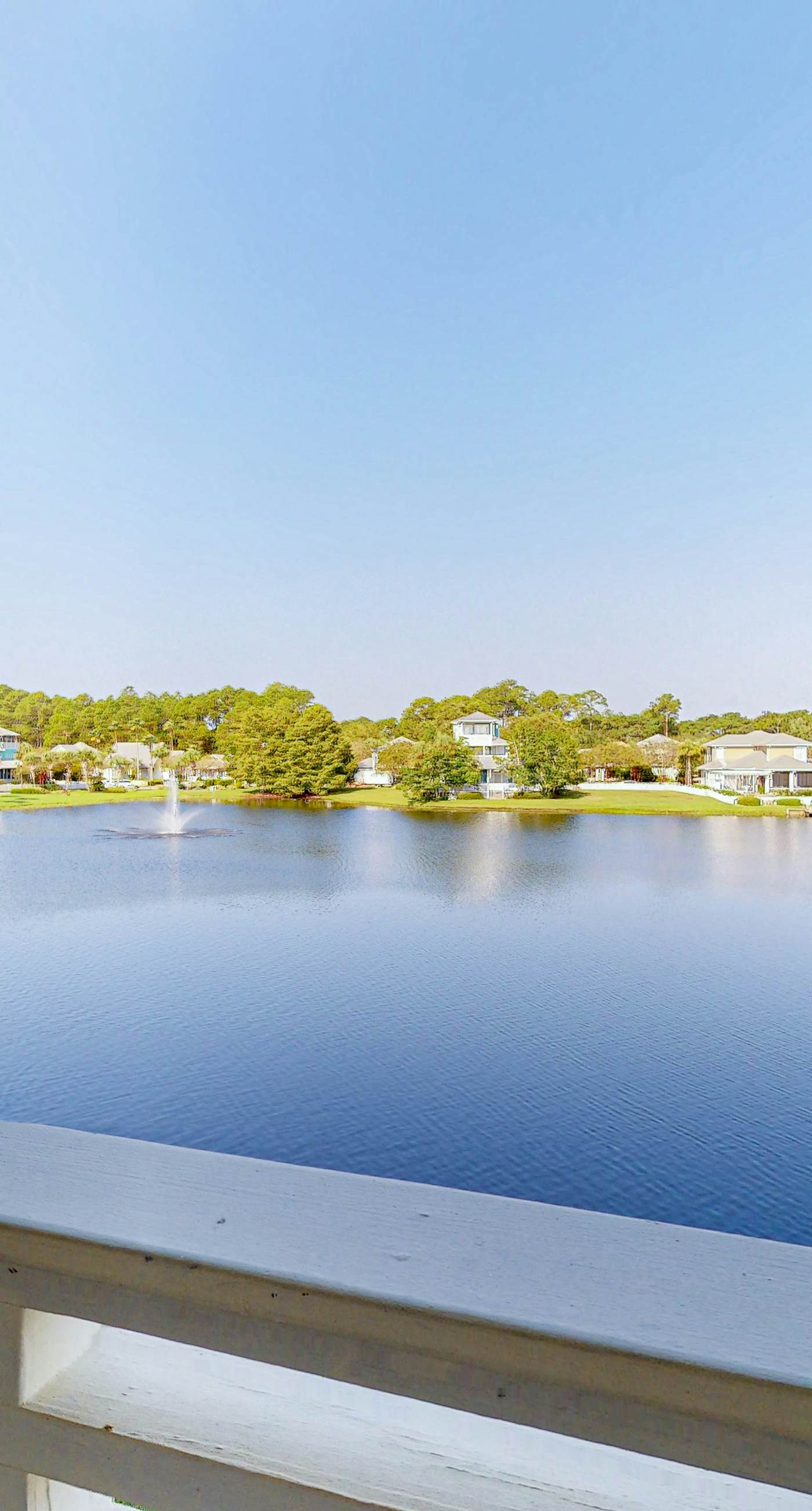 Lakefront condo with water-view balcony, private golf cart, resort pool & amenities