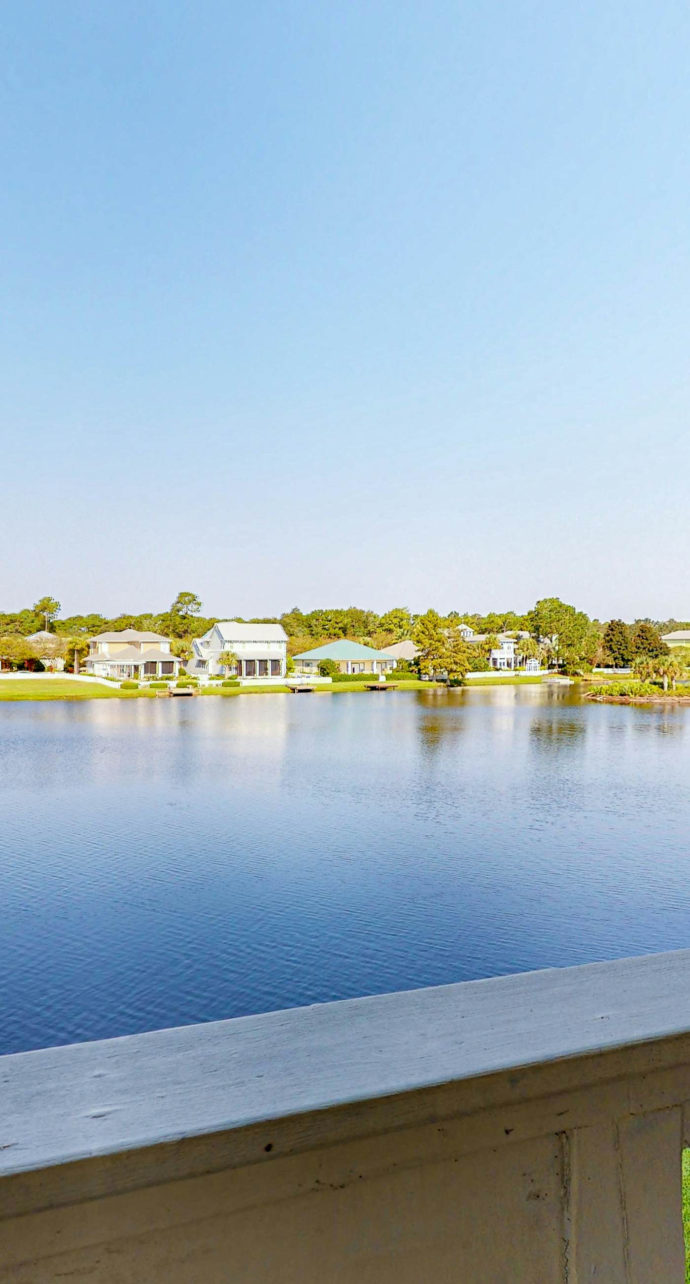 Lakefront condo with water-view balcony, private golf cart, resort pool & amenities