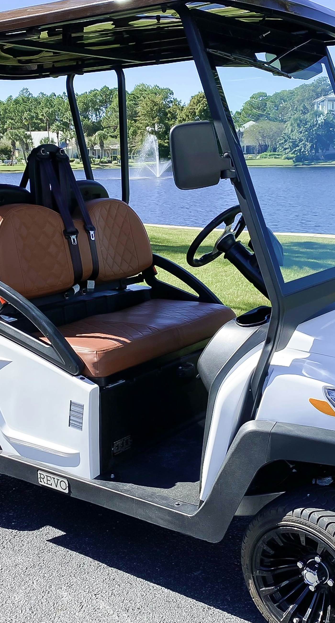 Lakefront condo with water-view balcony, private golf cart, resort pool & amenities