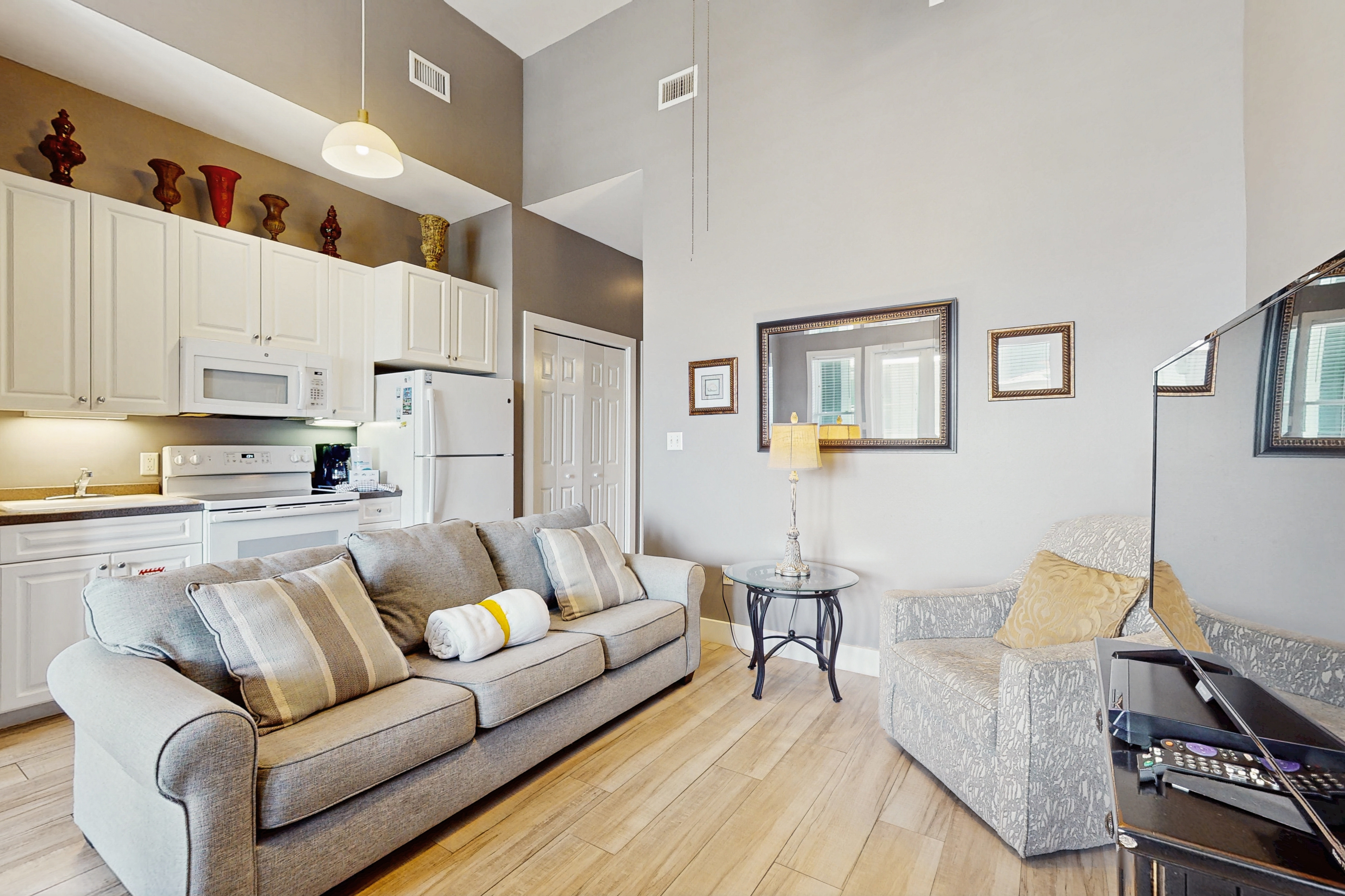 Spacious condo with large living area, private balcony & shared pool