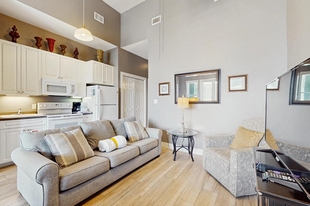 Spacious condo with large living area, private balcony & shared pool