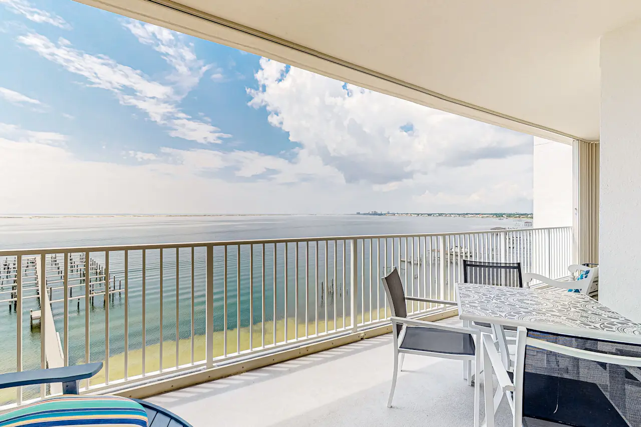 Waterfront condo with beach access, pools, balcony, central AC, & W&D ...