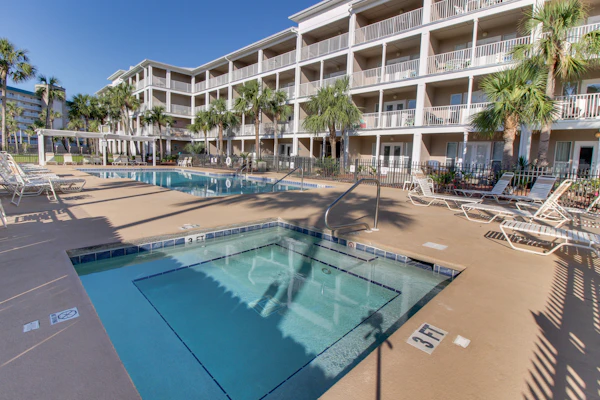 Modern beach condo with pool, hot tub, well-equipped kitchen, balcony, & W&D
