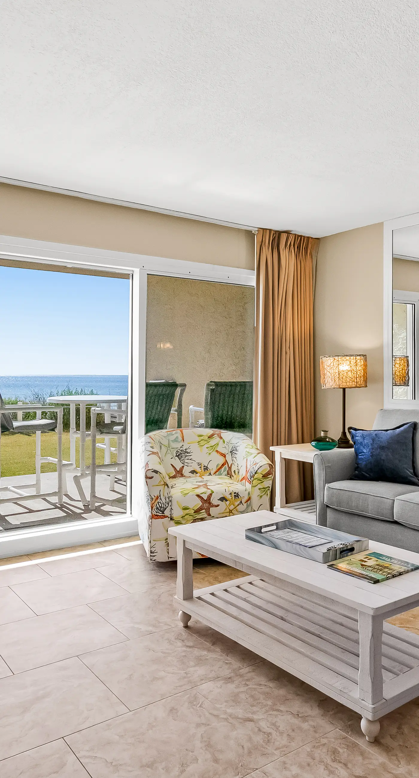 Ground floor oceanfront beachy condo with furnished patio, outdoor pool, gym