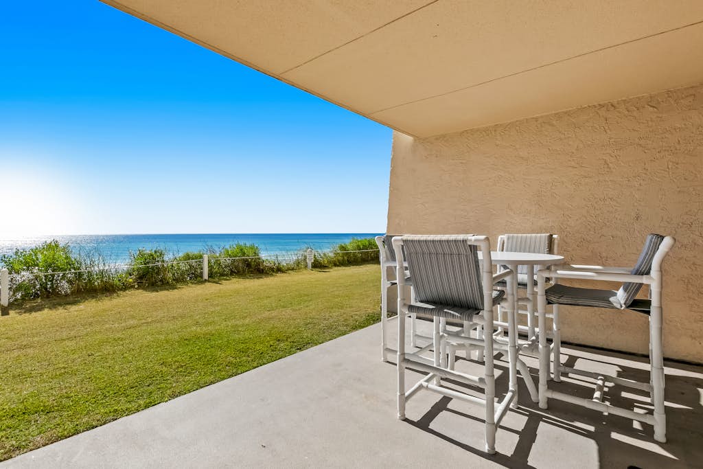 Ground floor oceanfront beachy condo with furnished patio, outdoor pool, gym