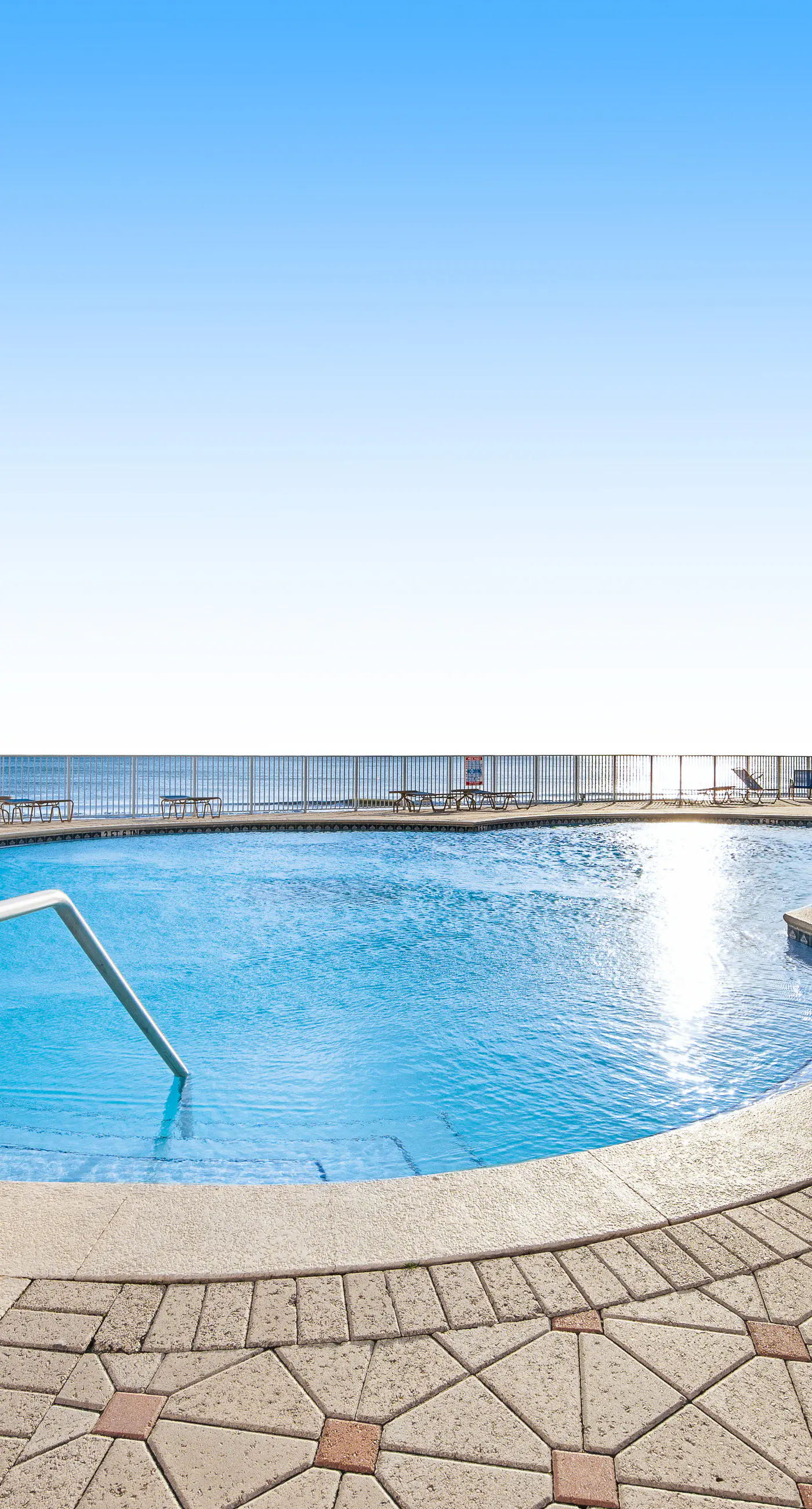 Ground floor oceanfront beachy condo with furnished patio, outdoor pool, gym