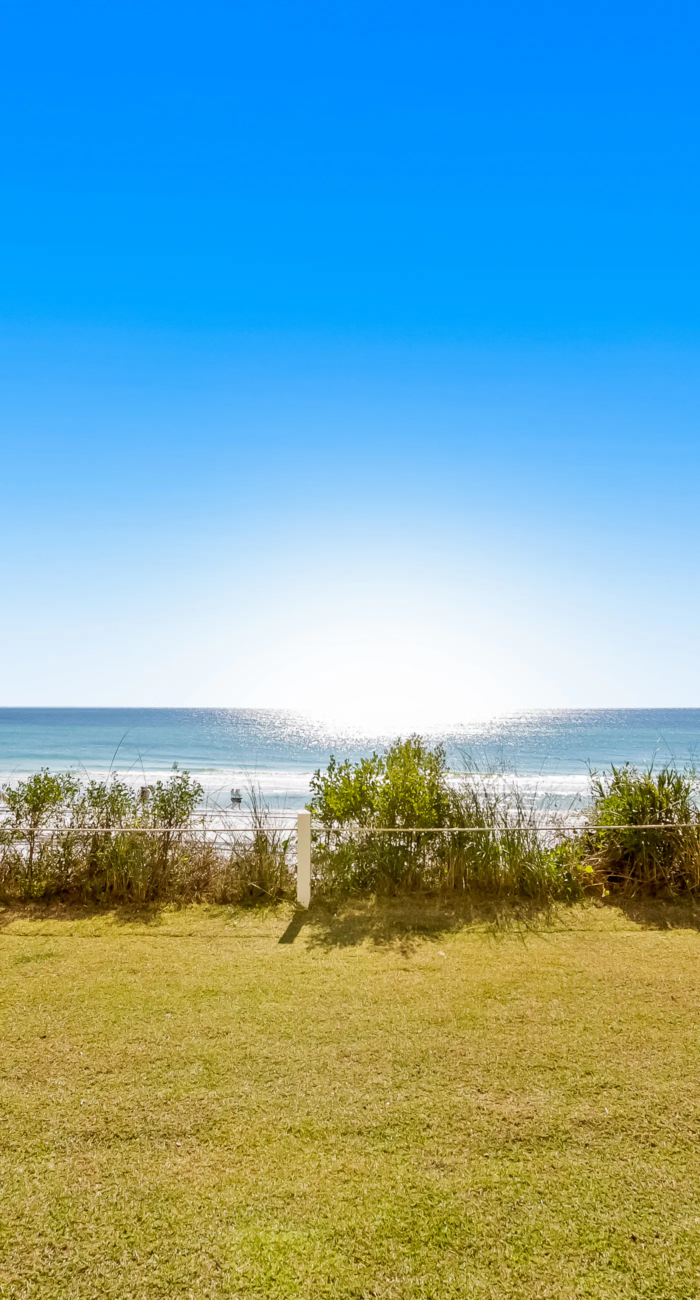 Ground floor oceanfront beachy condo with furnished patio, outdoor pool, gym