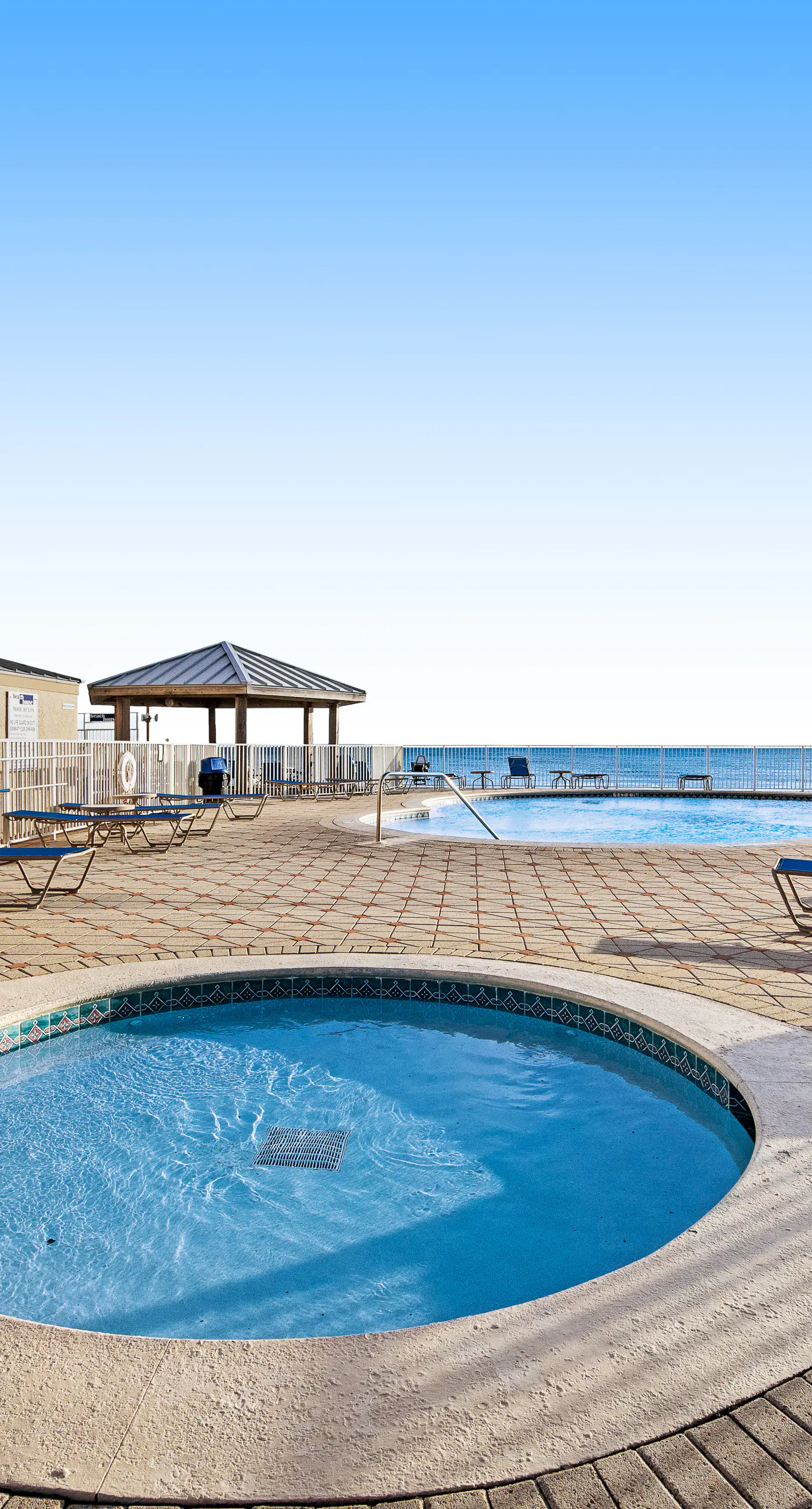Ground floor oceanfront beachy condo with furnished patio, outdoor pool, gym